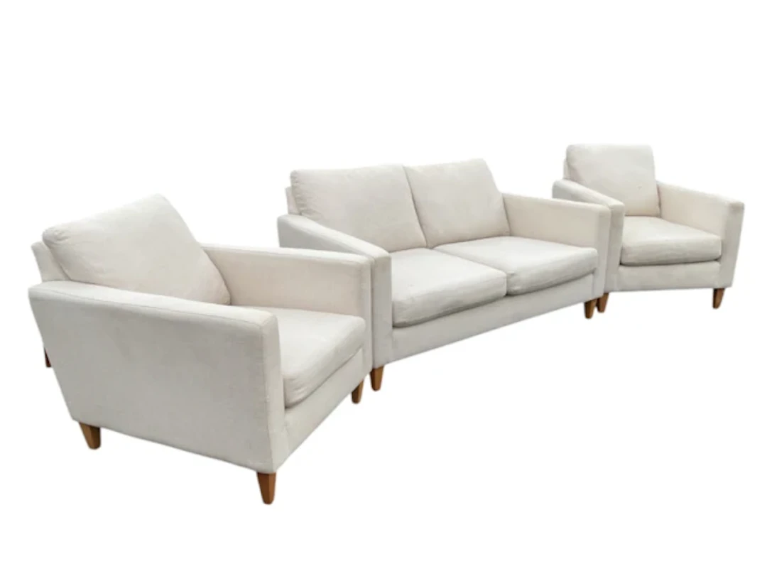 A contemporary linen upholstered three-piece suite with a pair of