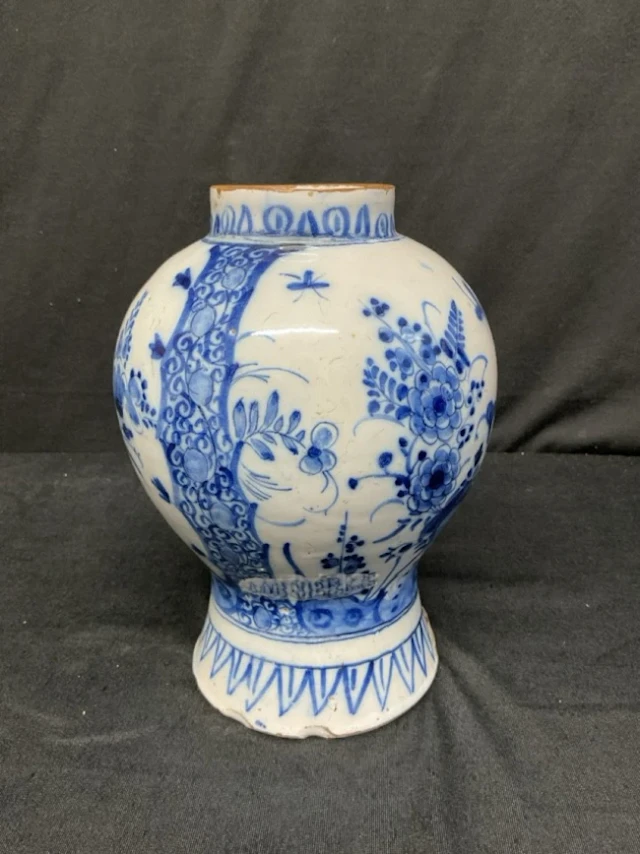 An C18th Dutch delft inverted baluster vase decorated in underglaze