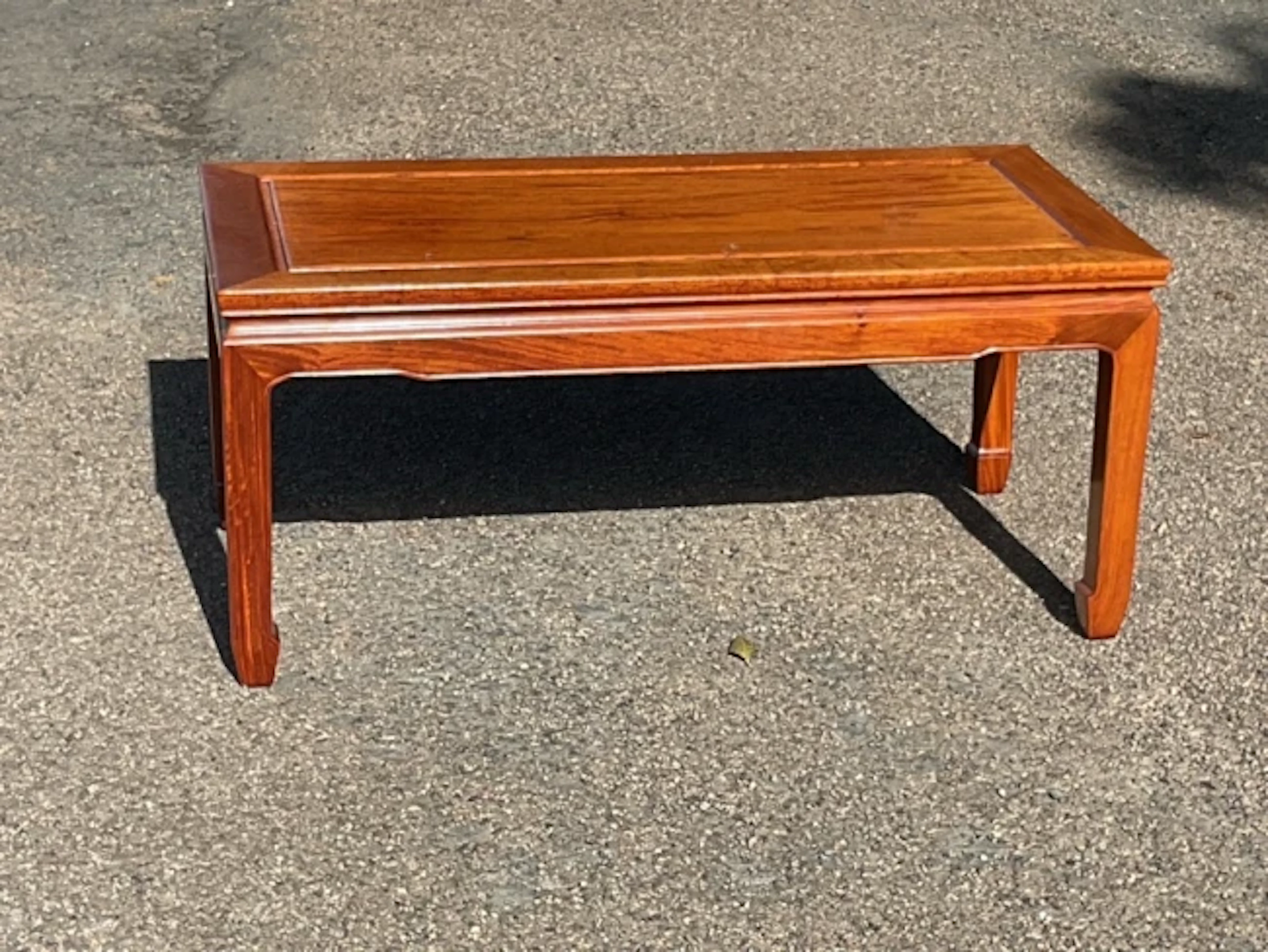 A Chinese rectangular mahogany coffee table with fielded panelled