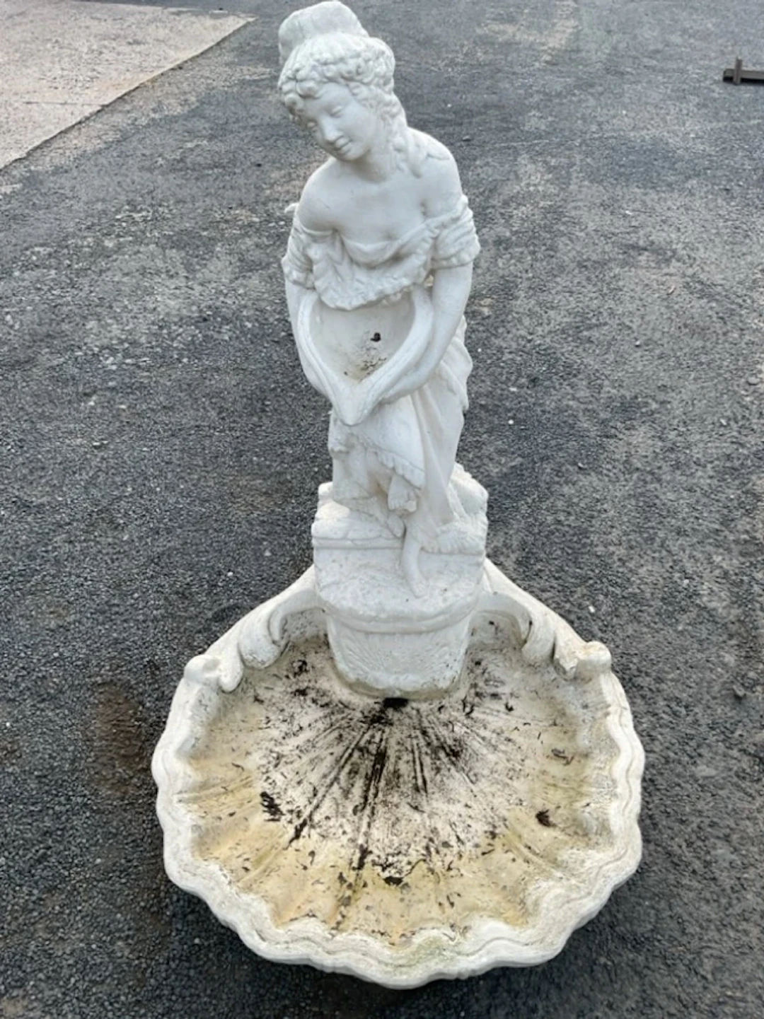A painted composition stone garden water feature modelled as the lady