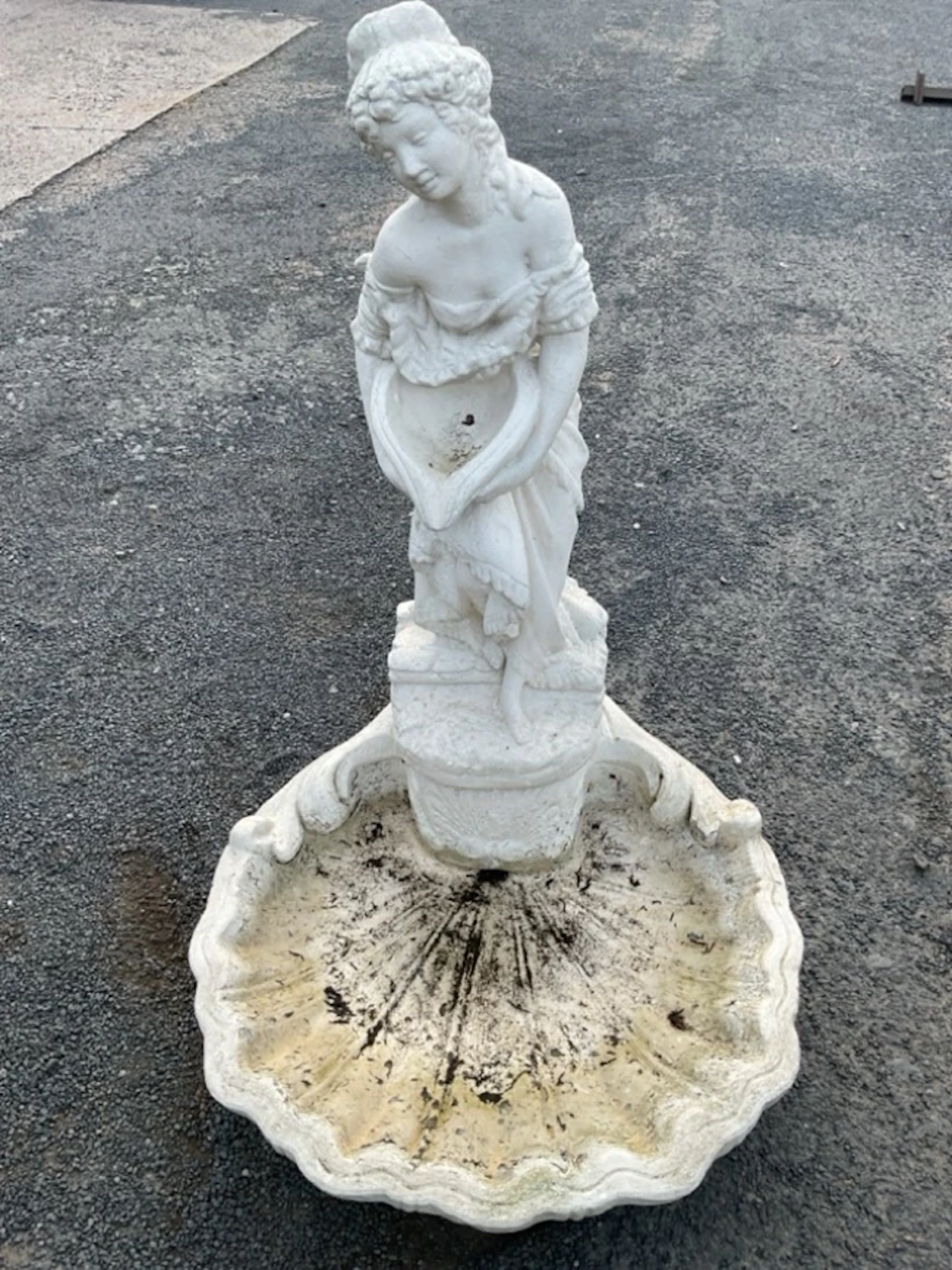 A painted composition stone garden water feature modelled as the lady