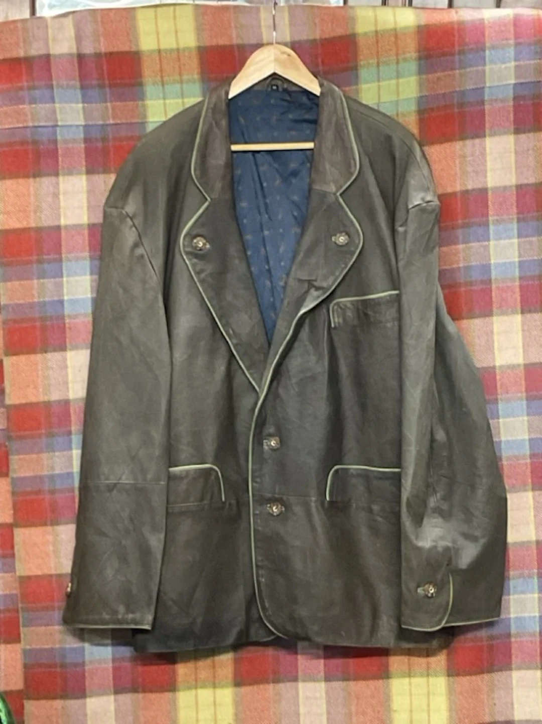 An Austrian leather shooting jacket with bitton-down lapel, fly pockets