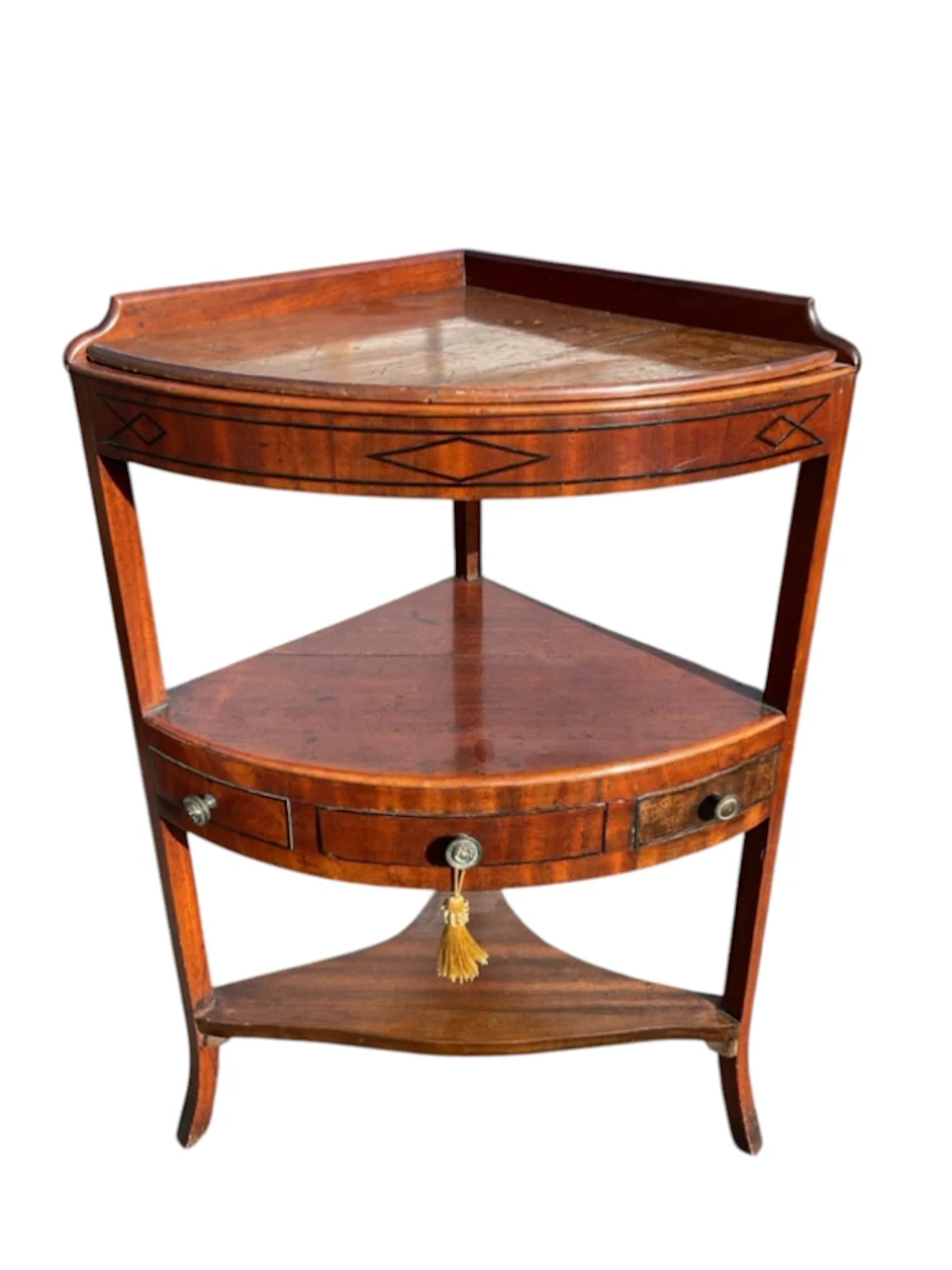 A nineteenth century mahogany corner washstand with shelf to pierced