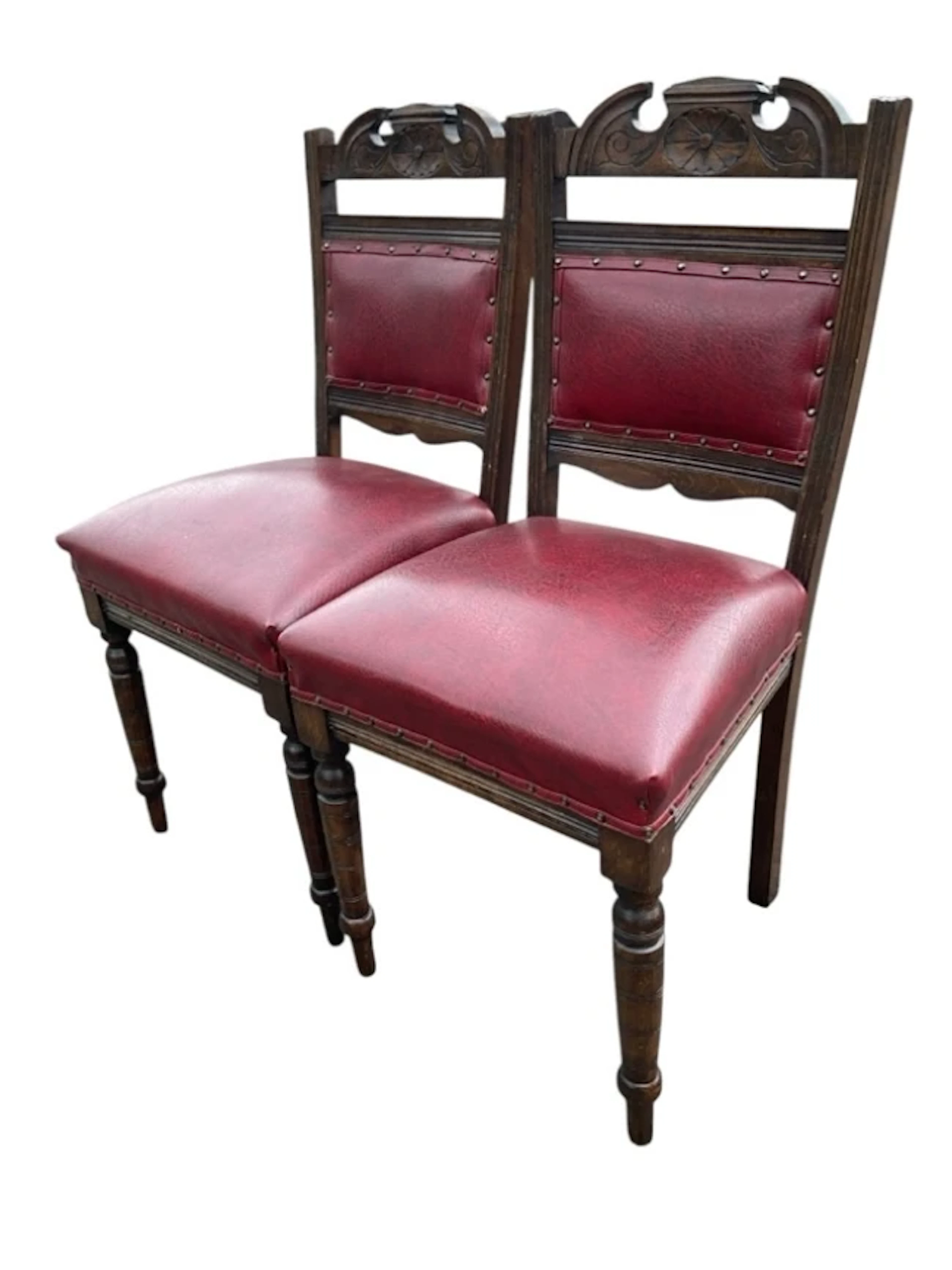 A pair of Edwardian stained chairs the broken arched crestrails carved