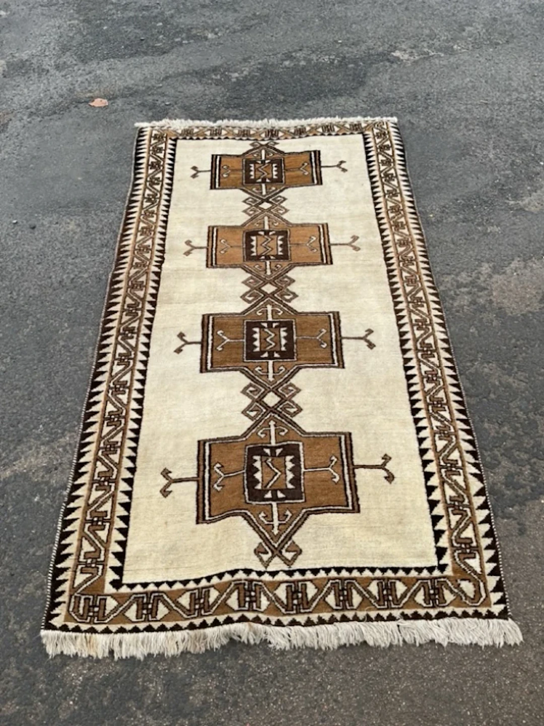 A Shirazi Gabbeh wool rug woven with four conjoined rectangular medallions