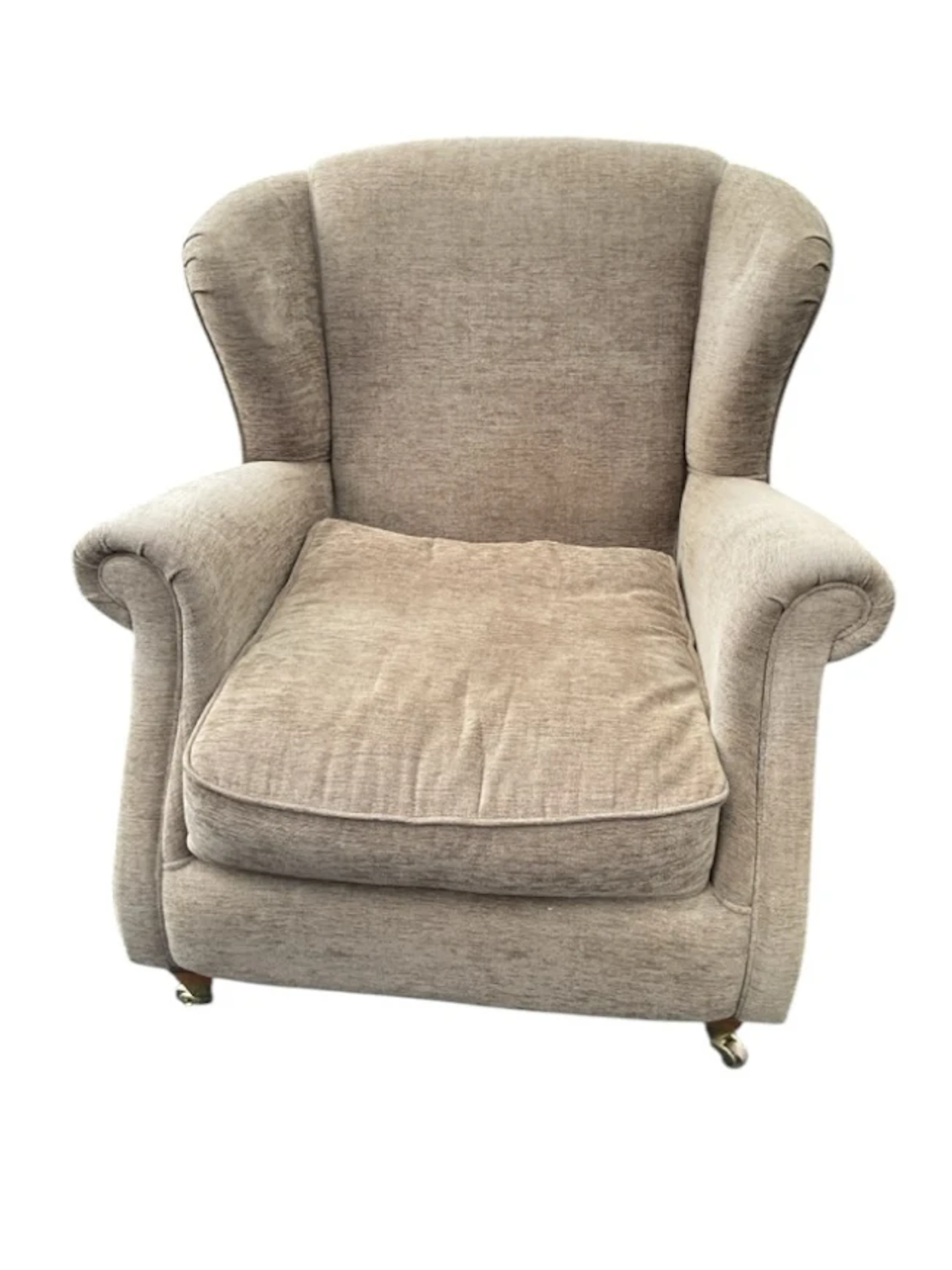 A wide upholstered wing armchair with padded back and outscrolled