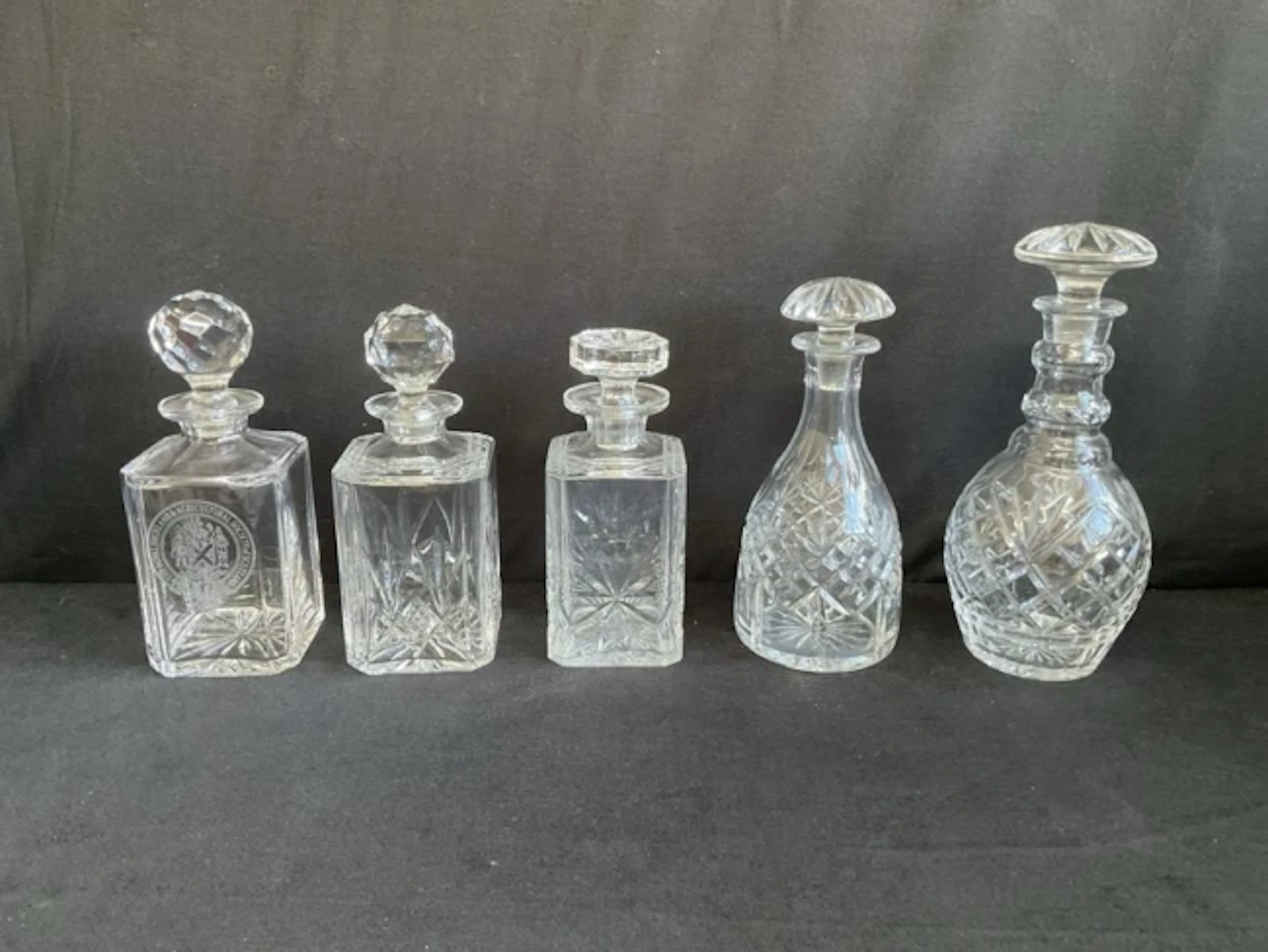 Three square cut glass decanters & stoppers with chamfered corners