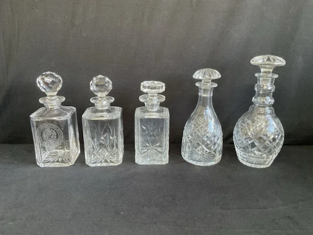 Three square cut glass decanters & stoppers with chamfered corners