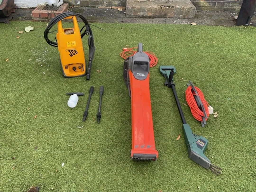 An electric Flymo garden vac with fabric collection bag; a JCB electric