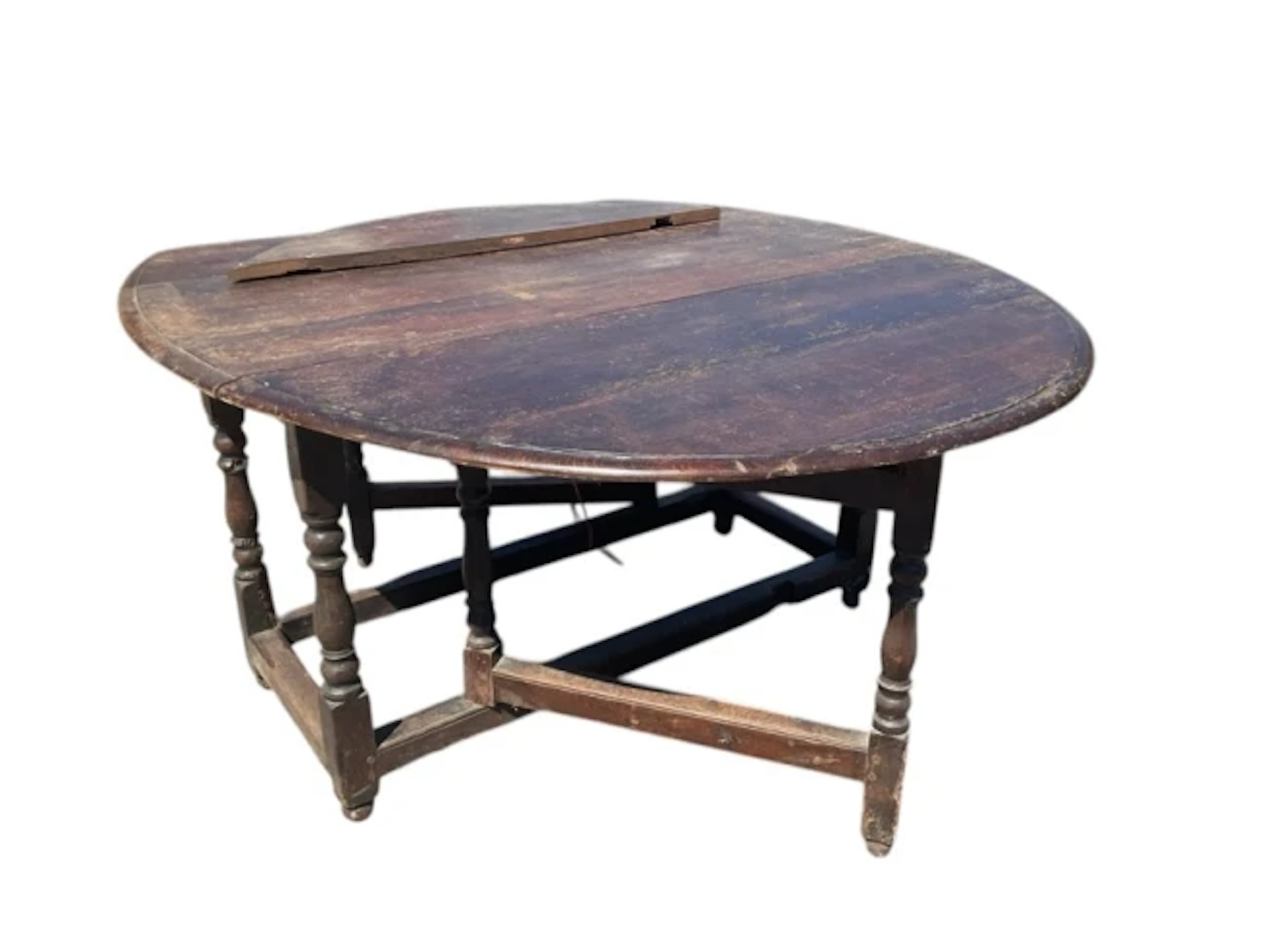 A C18th oak gateleg table with moulded oval top and two leaves opening