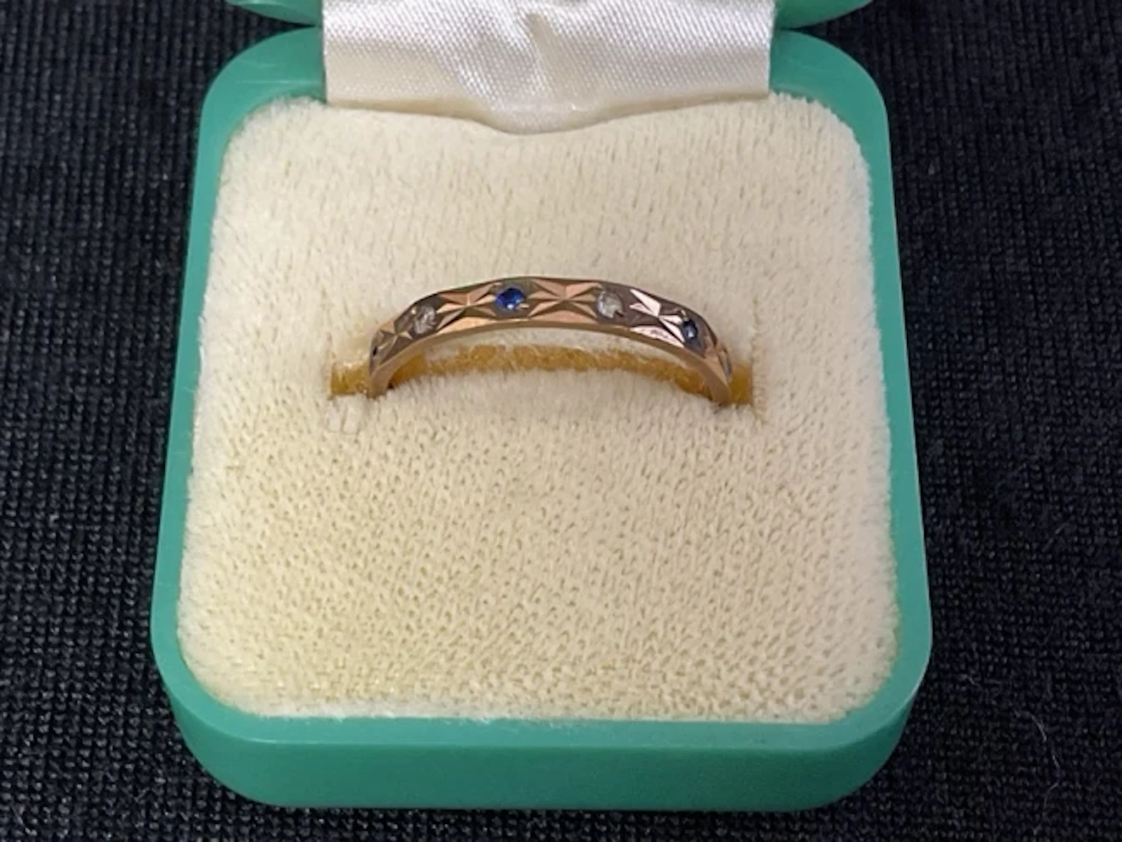 A hallmarked 9ct gold, sapphire and zircon eternity ring - size N. (1.3g)