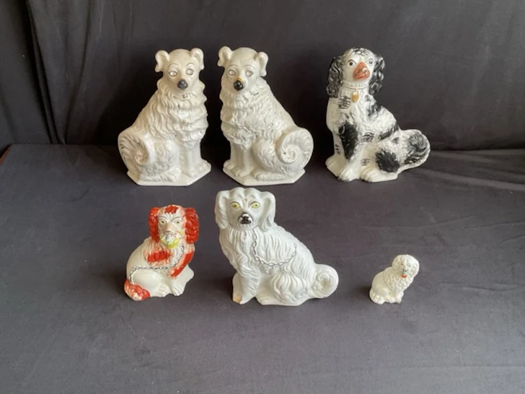 A pair of Staffordshire wally dogs with gilt decoration and glass