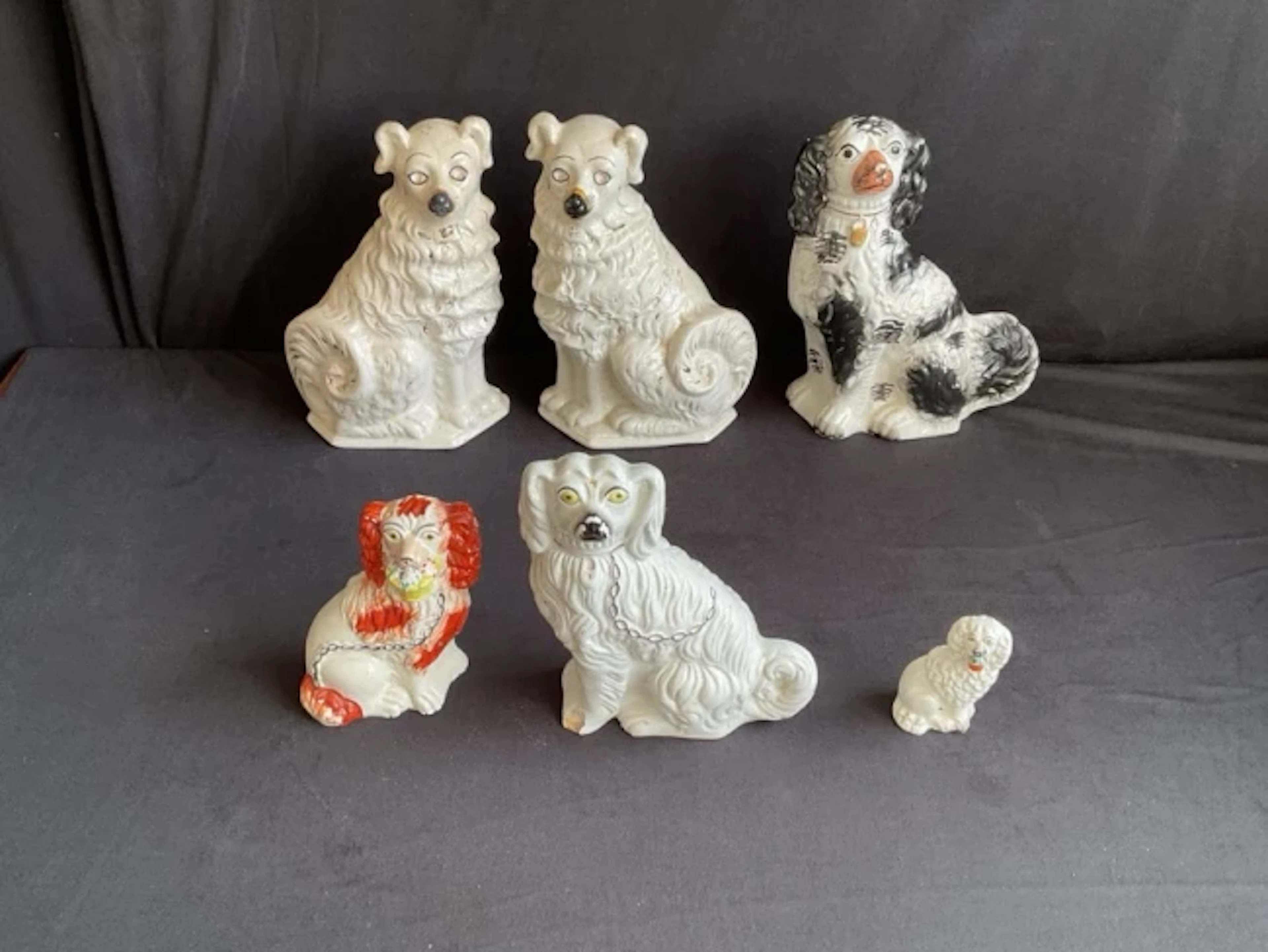 A pair of Staffordshire wally dogs with gilt decoration and glass