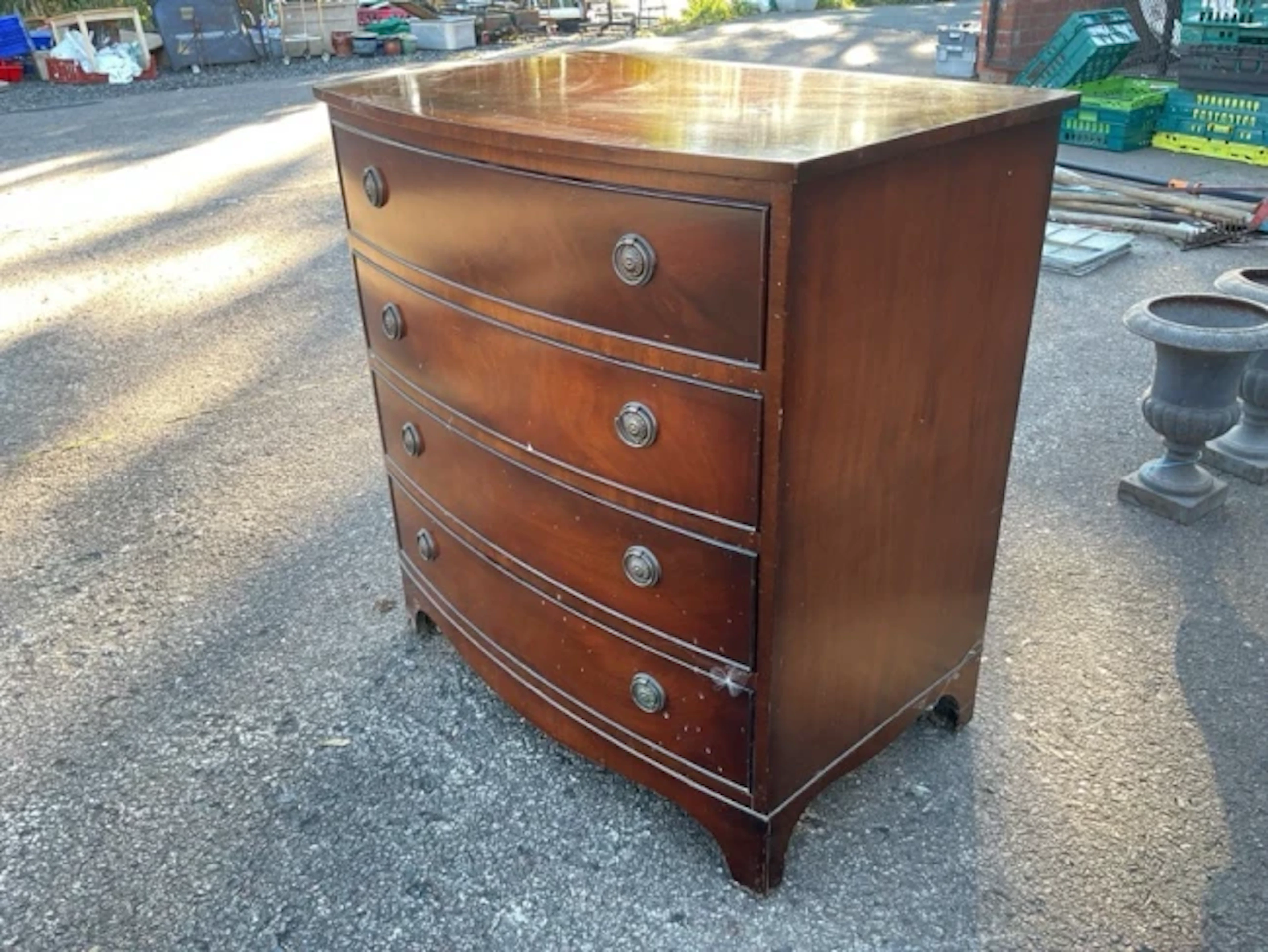 A bowfronted mahogany chest of four long drawers mounted with brass