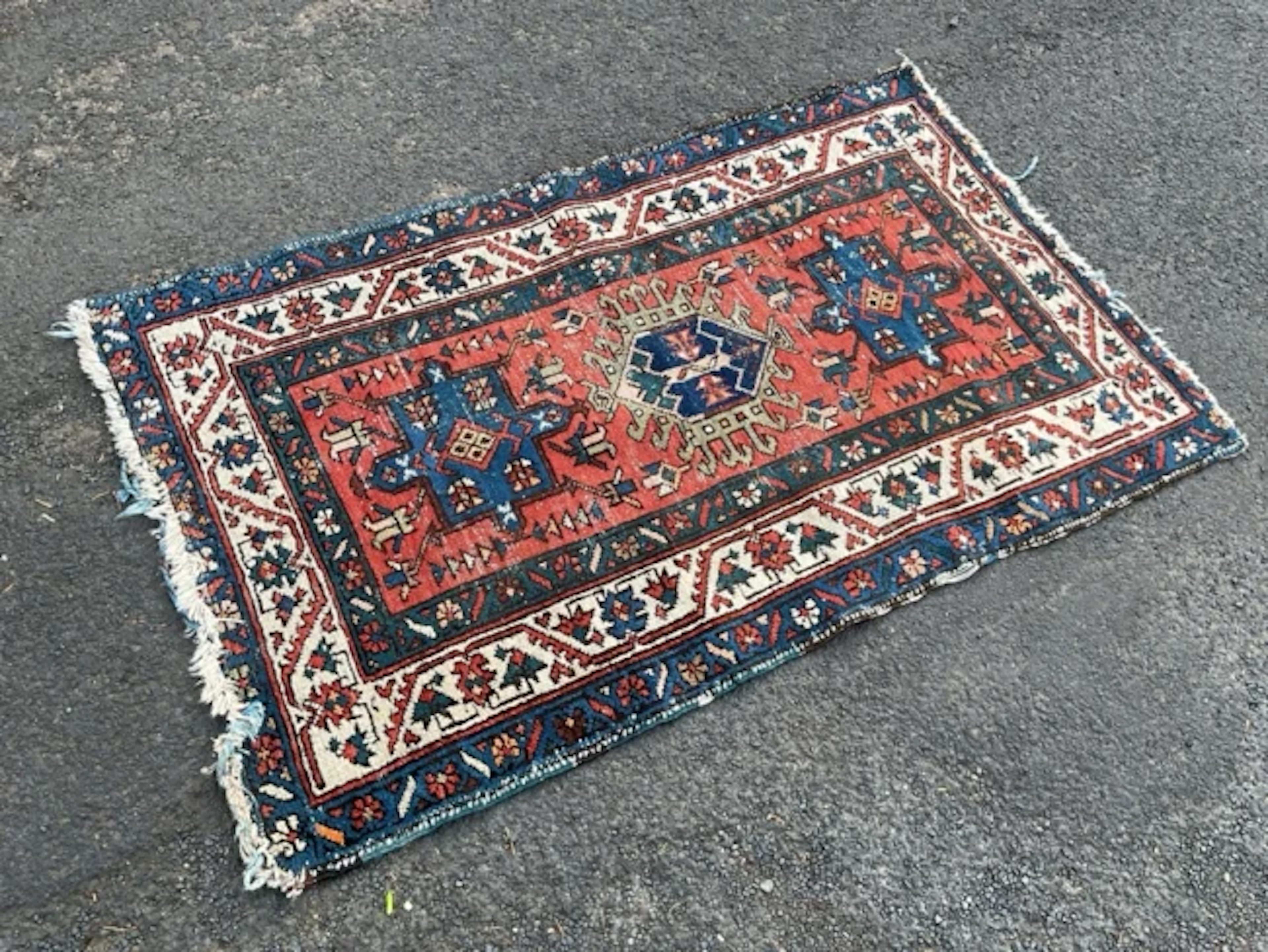 A Heriz Karadja wool rug with central hexagonal hooked medallion flanked