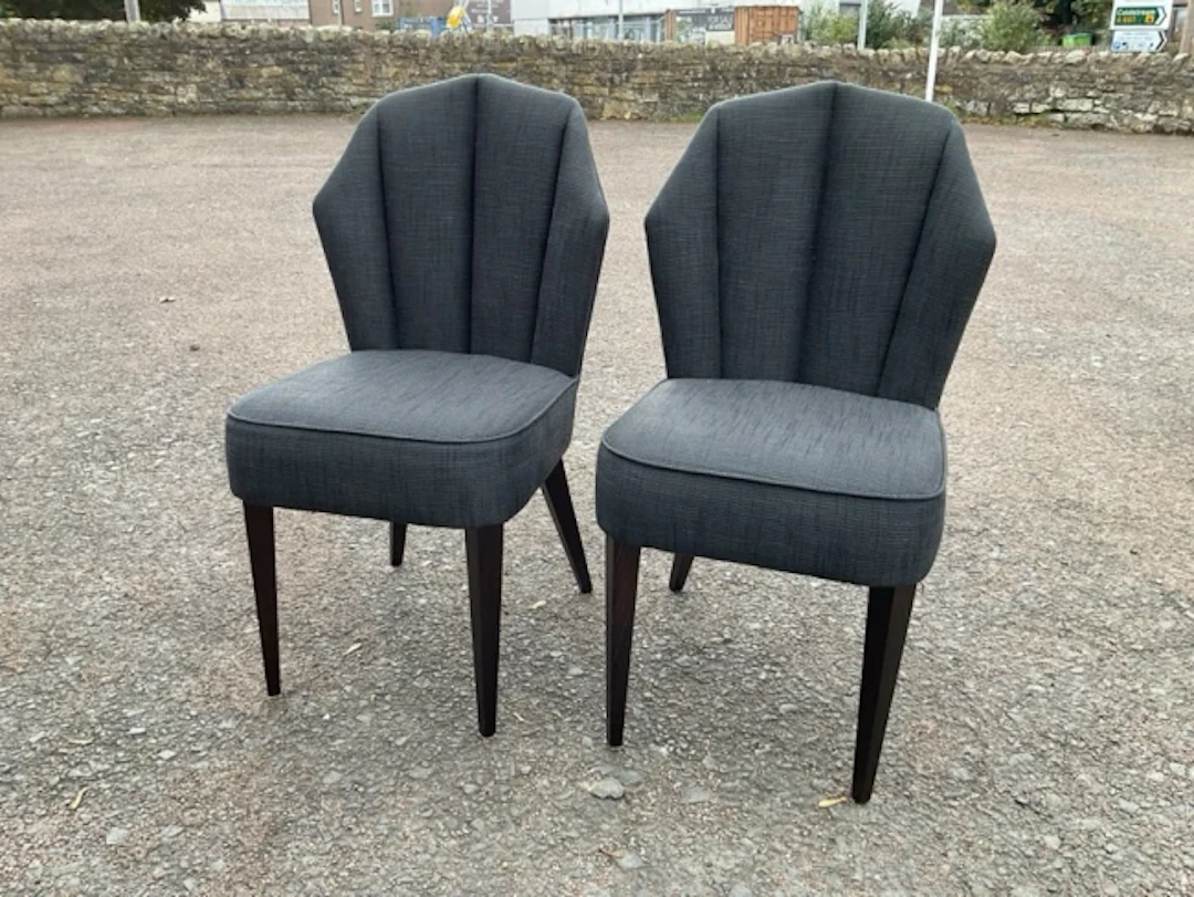 A pair of contemporary upholstered side chairs with angled fluted