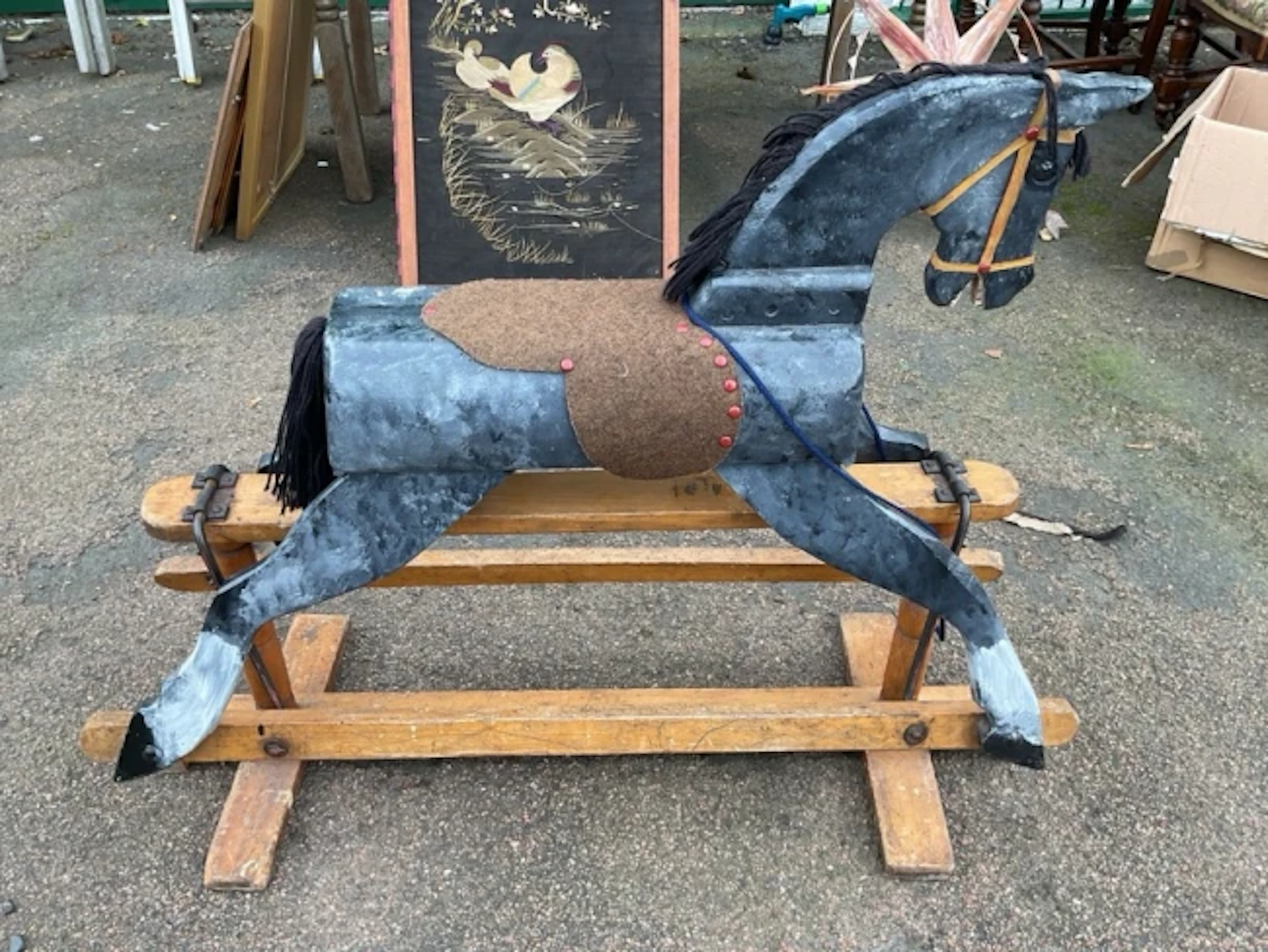 A grey dapple painted rocking horse on stand with turned column supports