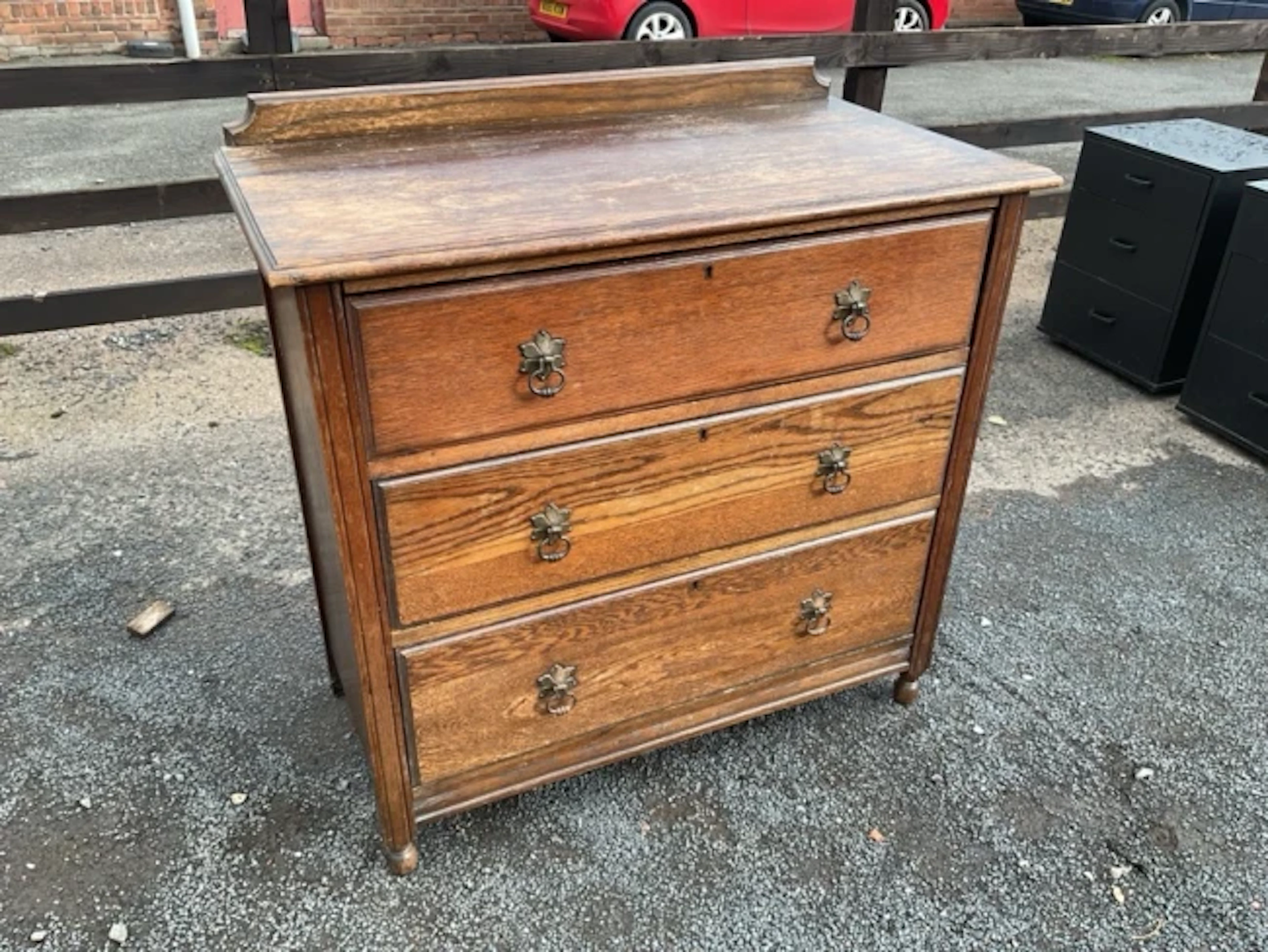 An oak chest with shaped upstand back and rectangular moulded top