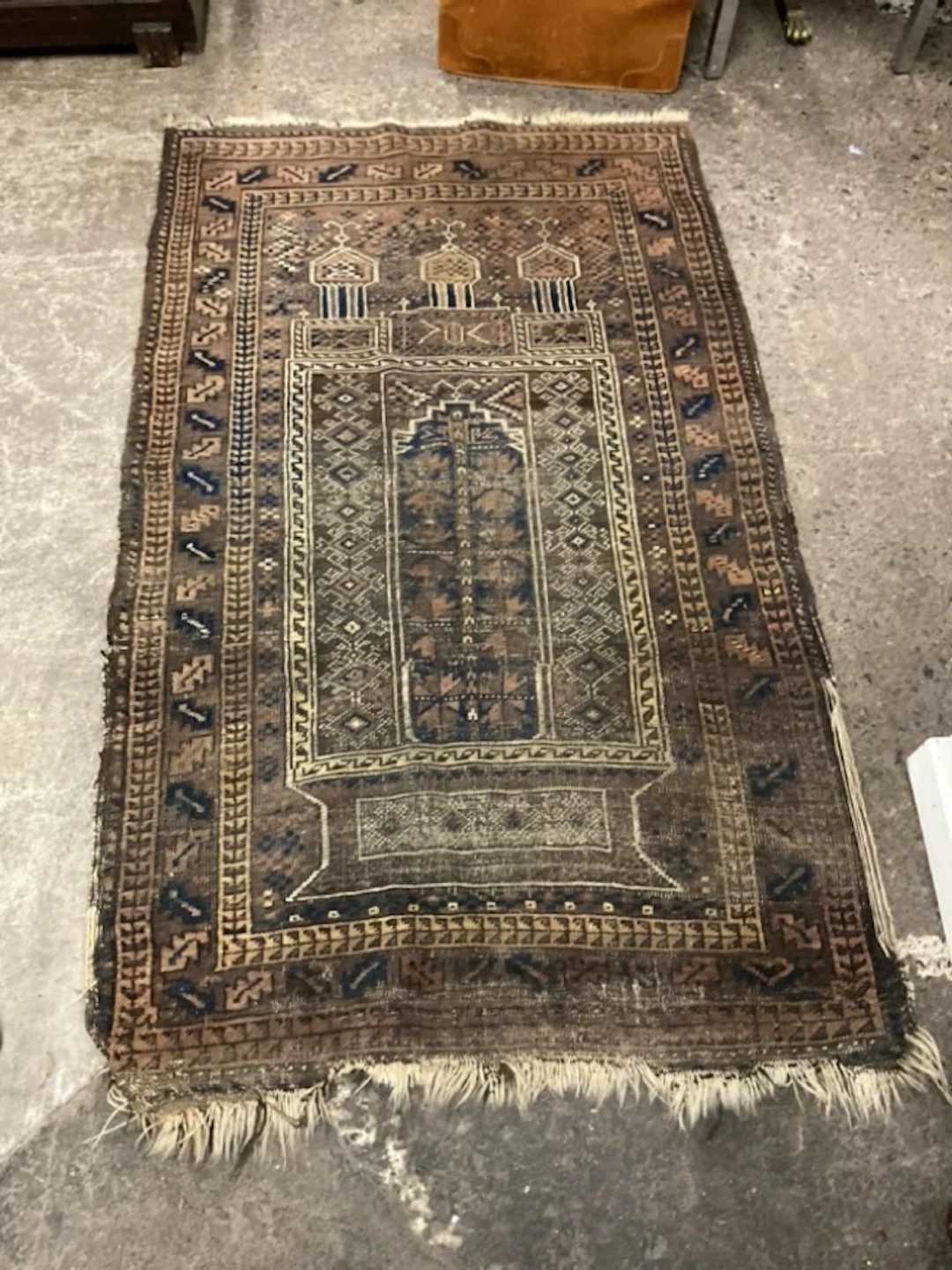 A Taimani Baluch wool prayer rug with central three-domed mihrab on