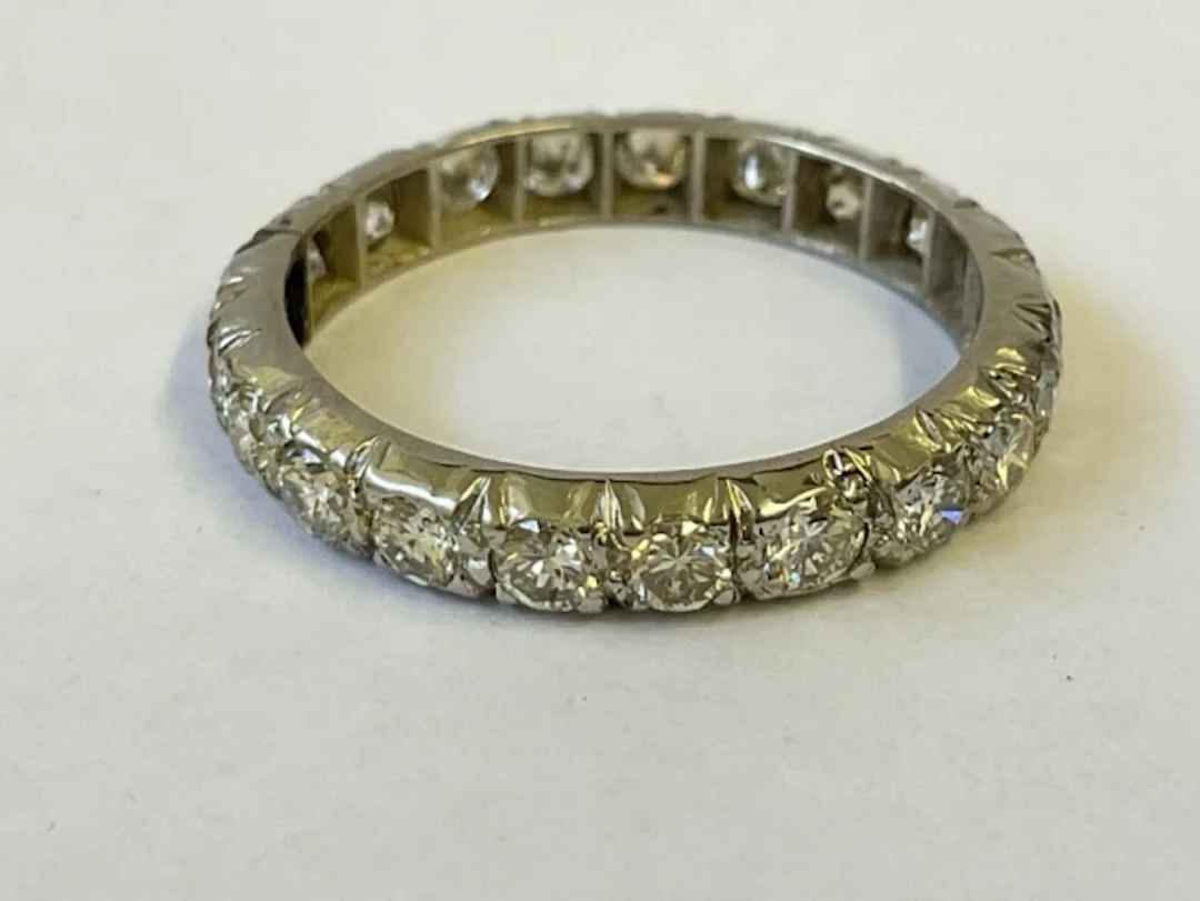 A platinum diamond eternity ring set with 21 brilliant cut diamonds