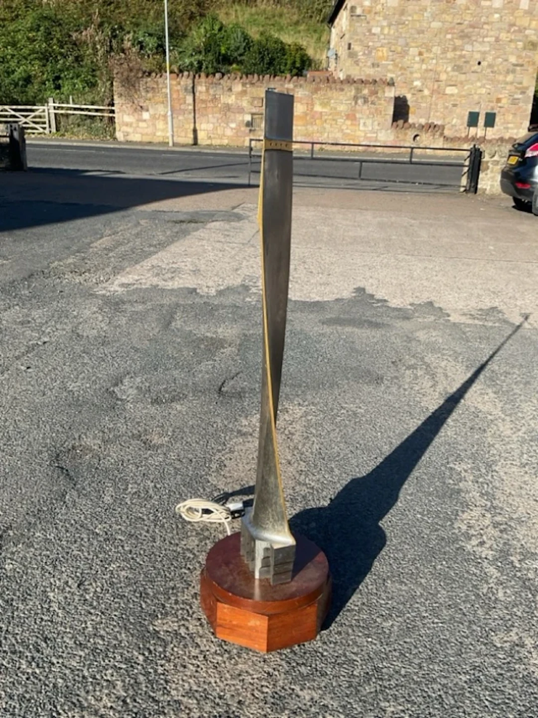 A revolving sculpture formed from an aircraft engine with shaped fin
