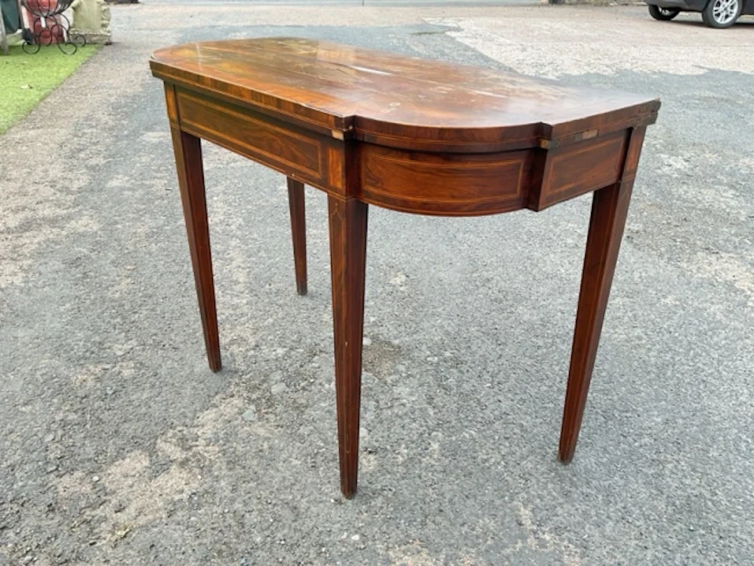 A nineteenth century mahogany turn-over-top card table with baize