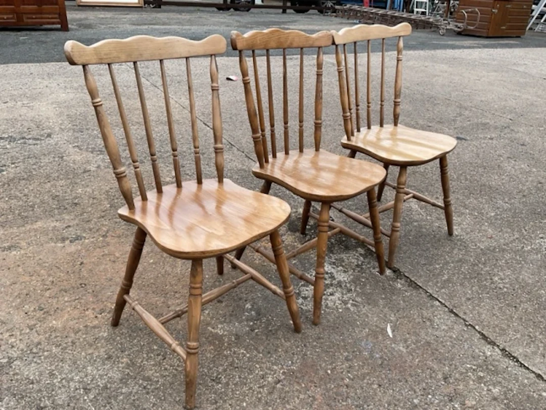 A set of three Victorian style beech kitchen chairs with wavy crestrails