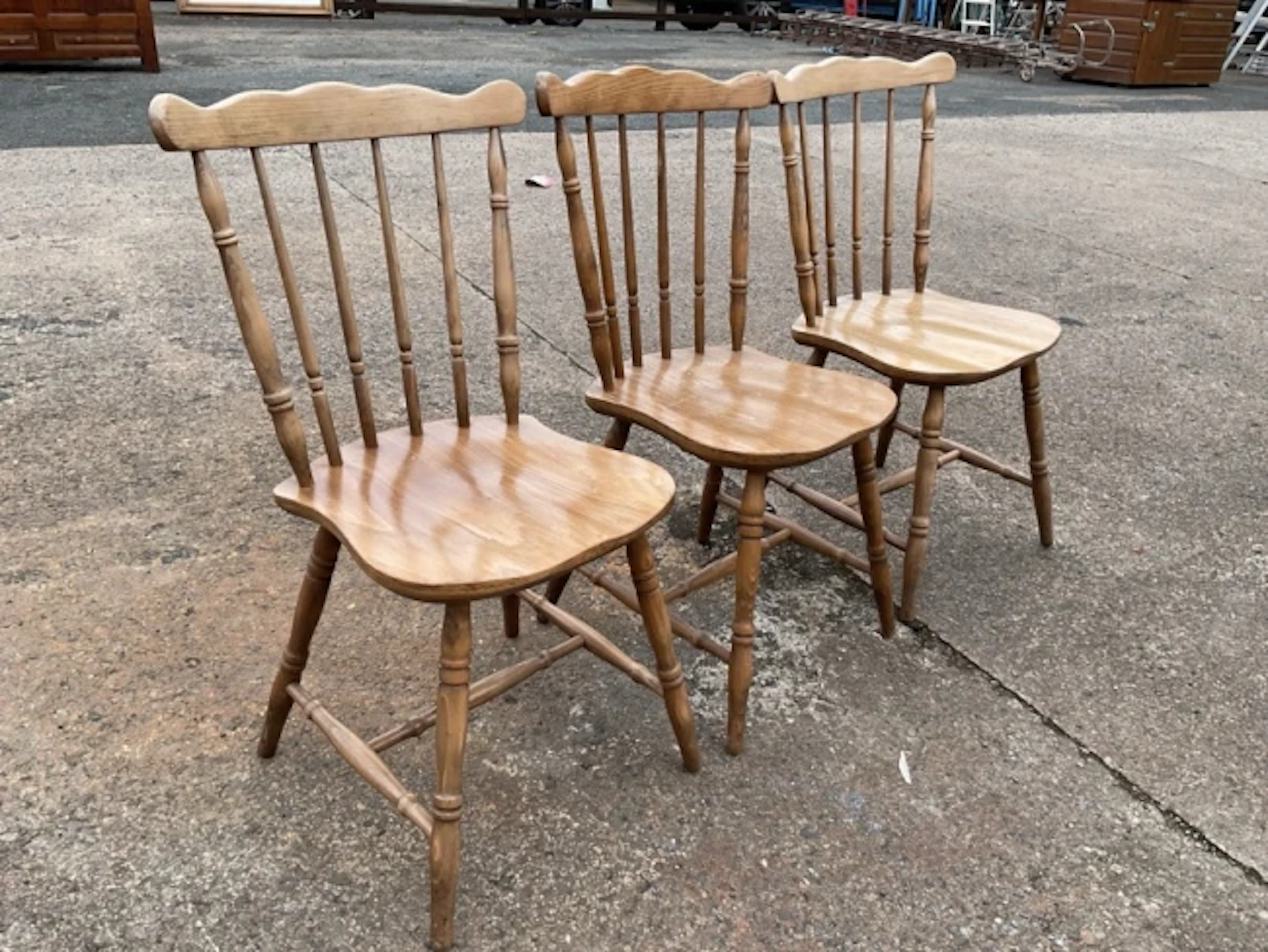A set of three Victorian style beech kitchen chairs with wavy crestrails