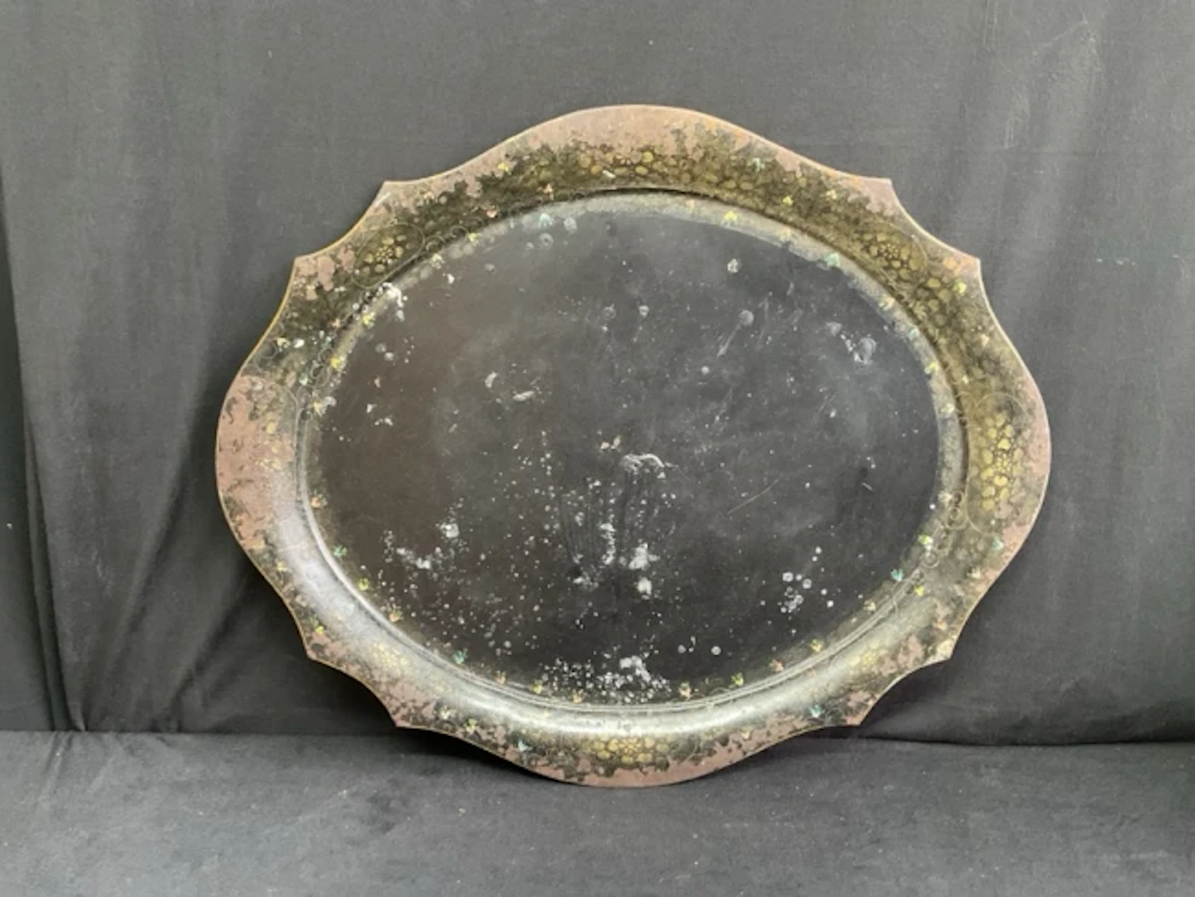 A large oval Pontypool japanned tin tray with scalloped with scalloped