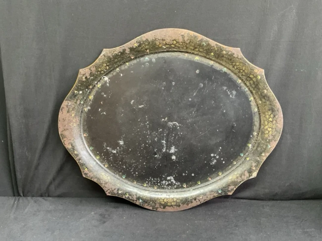 A large oval Pontypool japanned tin tray with scalloped with scalloped