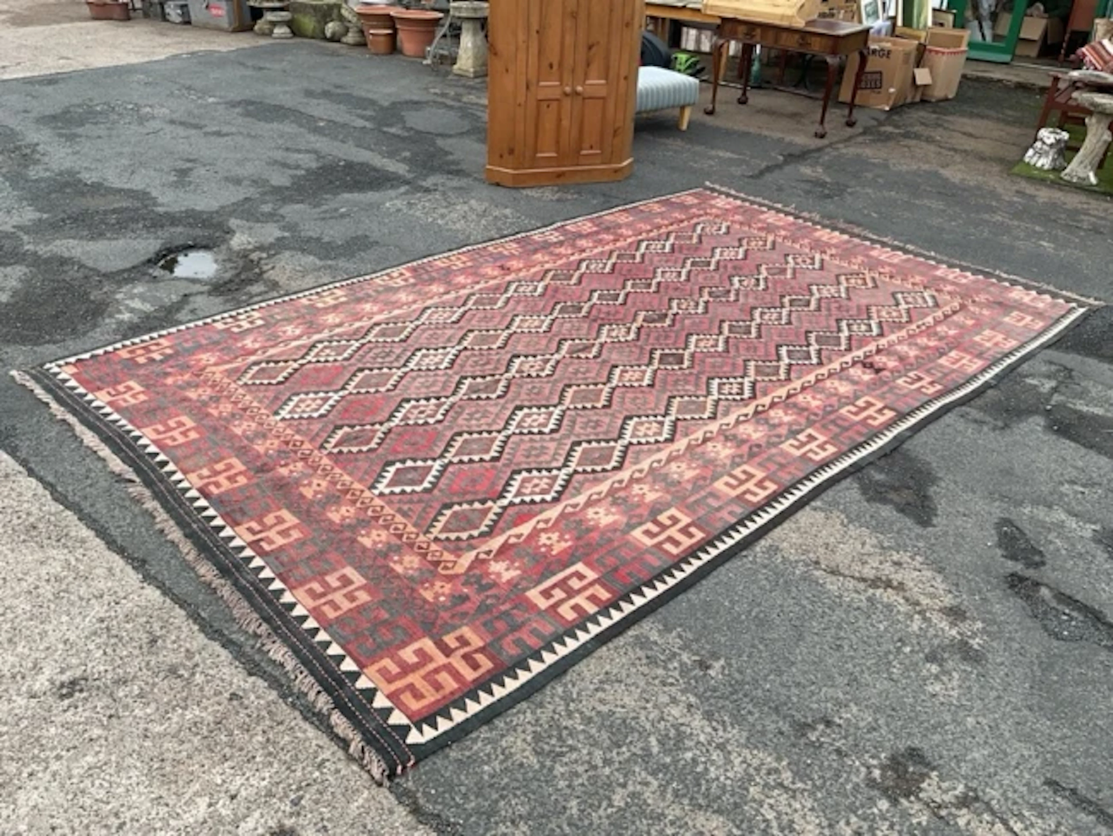 An Anatolian kilim wool rug with rows of interlocking zigzag lozenge