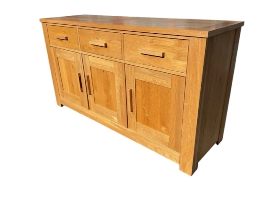 A contemporary oak dresser with three frieze drawers above panelled