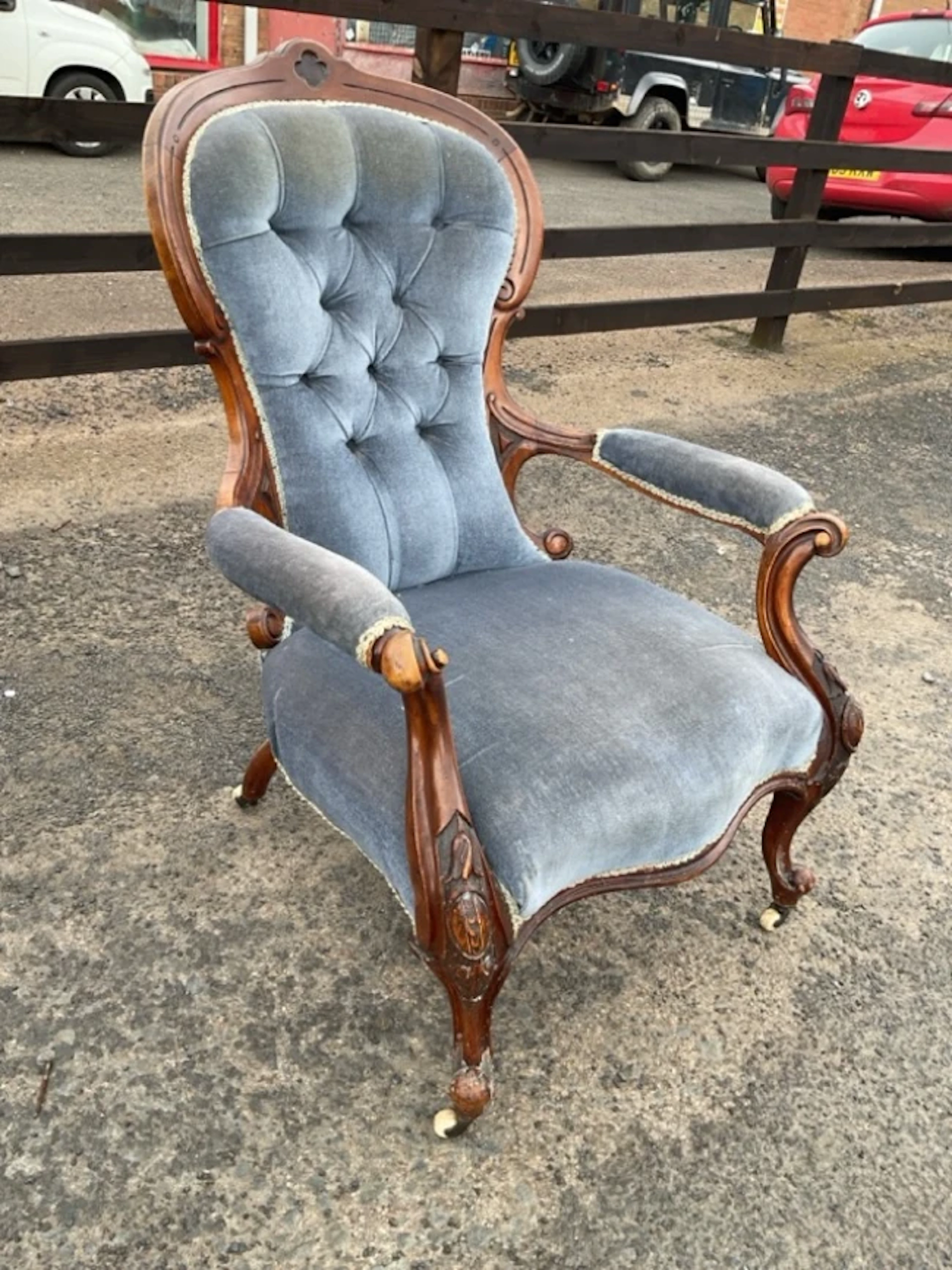 A Victorian spoonback button upholstered mahogany chair with scrolled