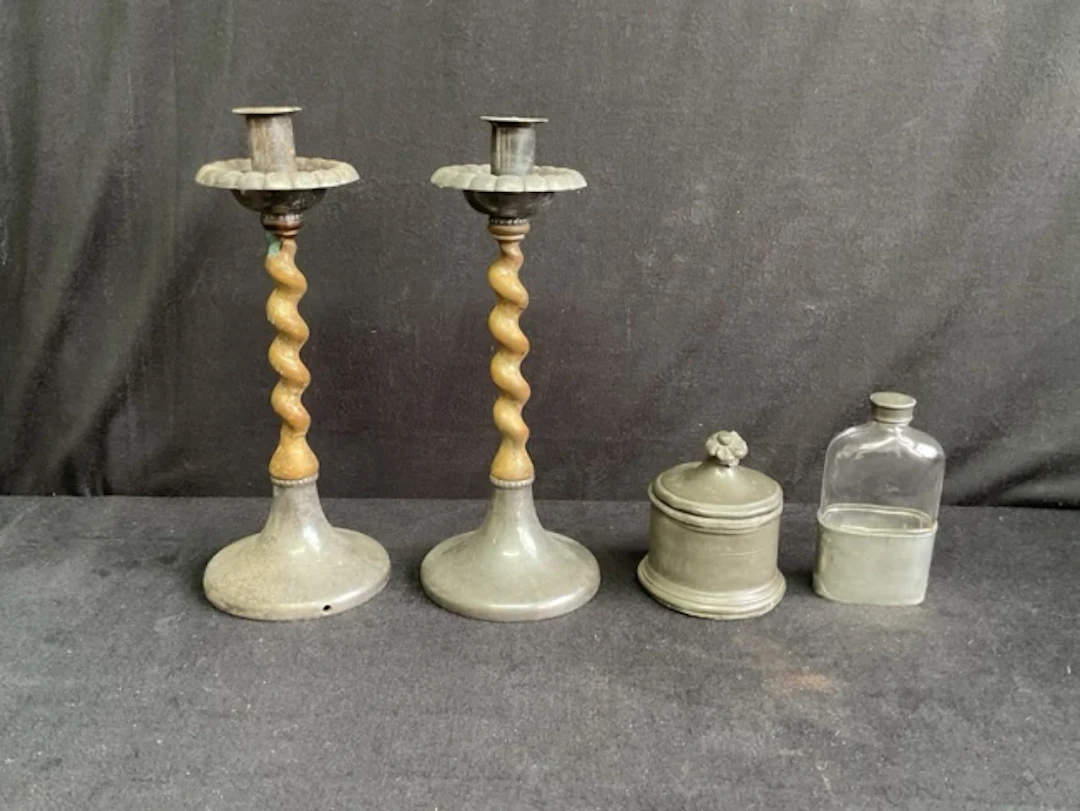 A pair of arts and crafts hammered pewter and fruitwood barleytwist
