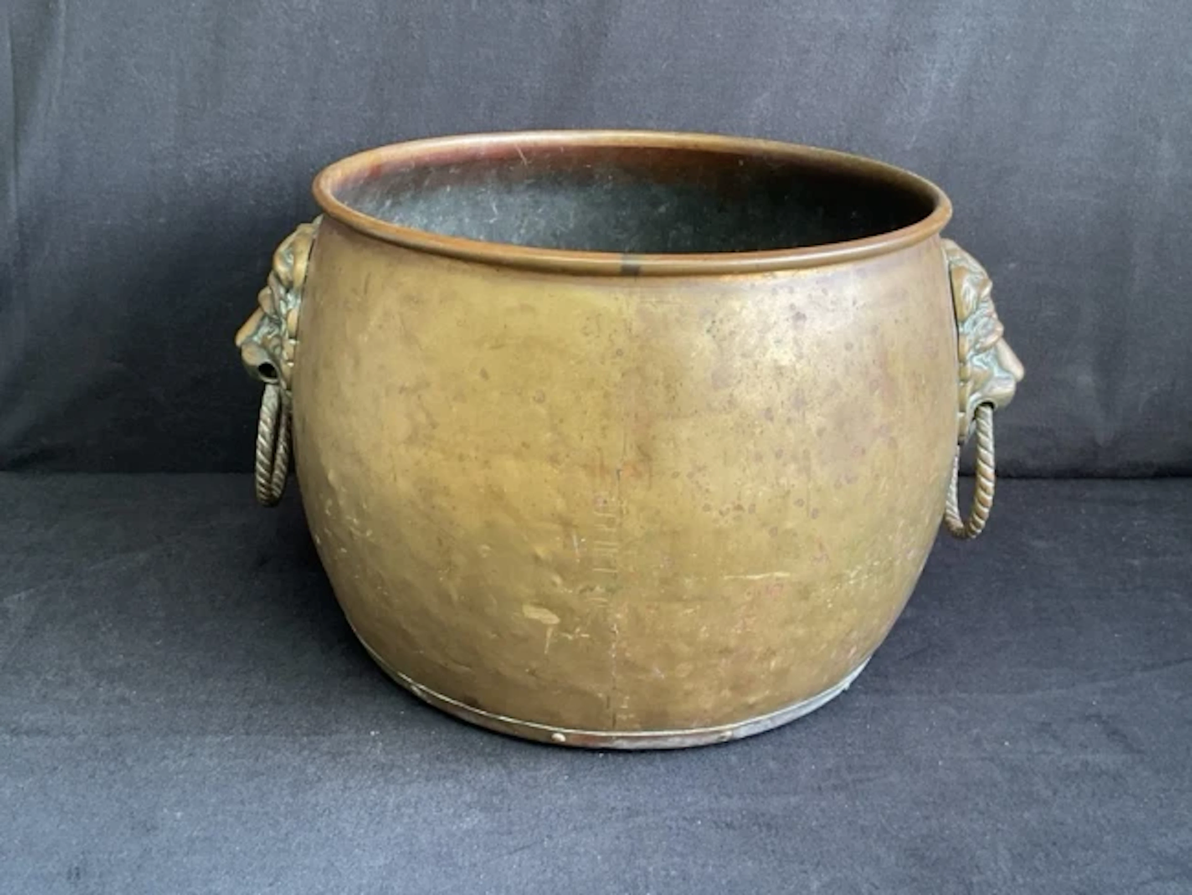 An Edwardian circular brass coal hopper of slightly bulbous form with