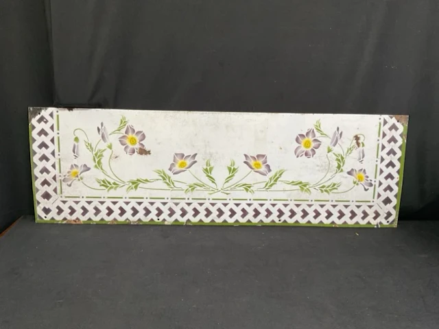 A French art nouveau enamelled metal splashback with stencilled decoration