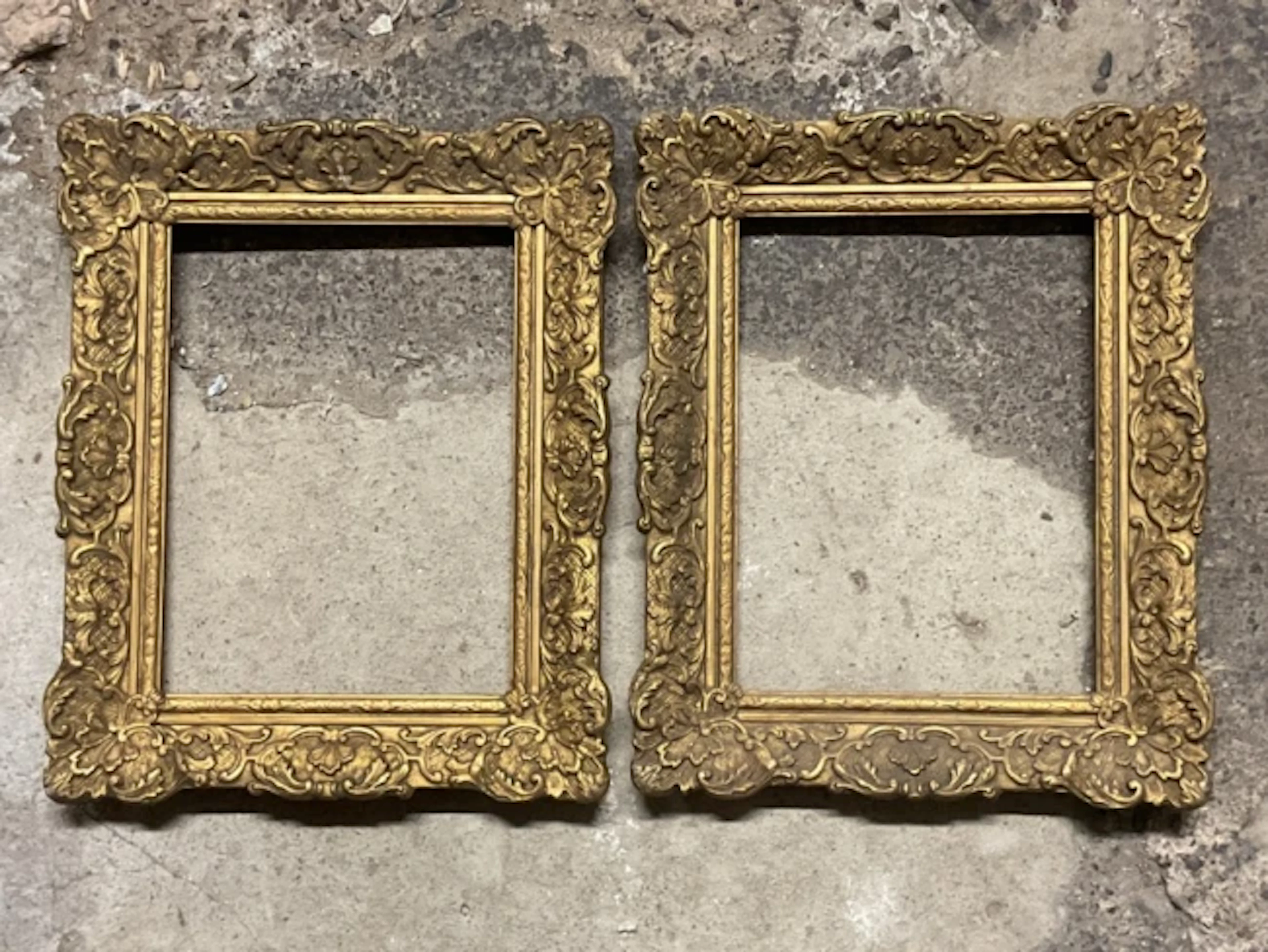 A pair of Régence style giltwood and gesso picture frames with fan