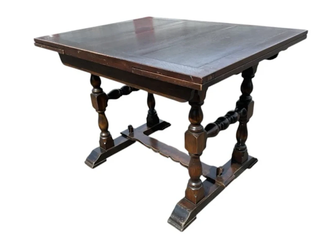 A Jacobean style oak draw-leaf table having rectangular top with two