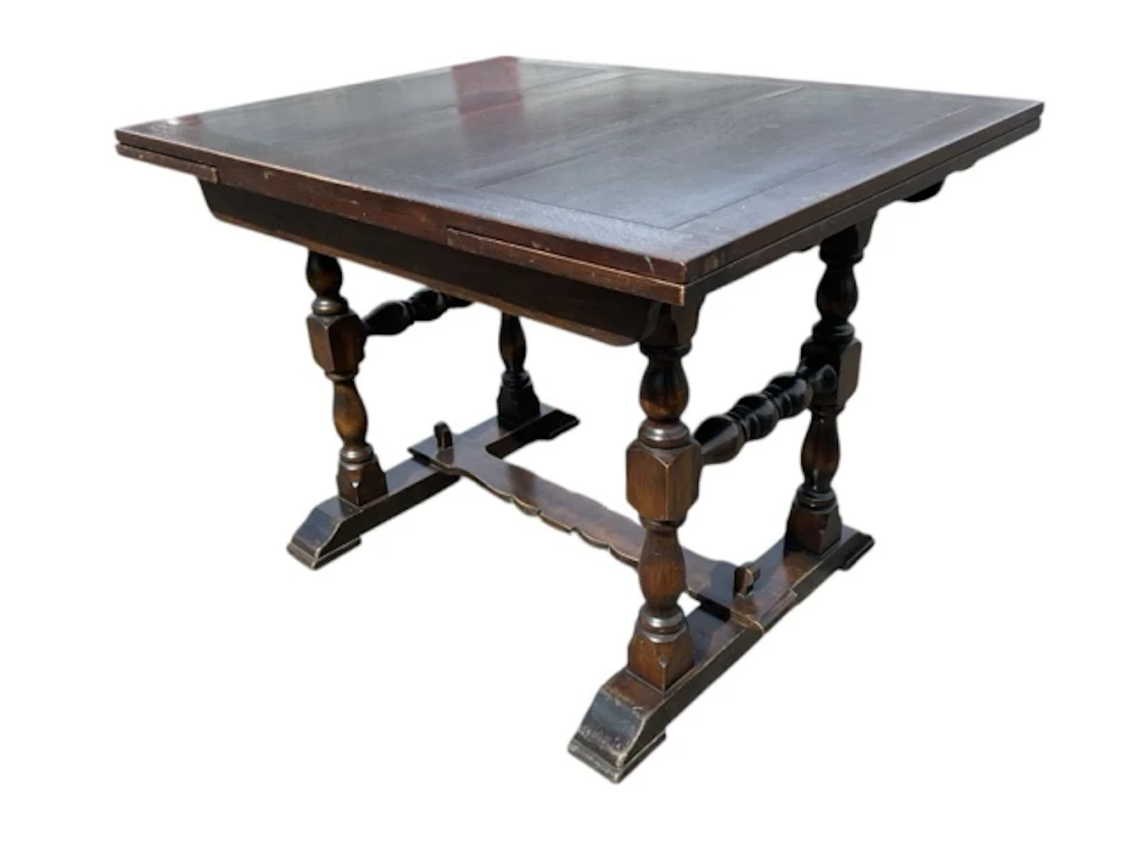 A Jacobean style oak draw-leaf table having rectangular top with two