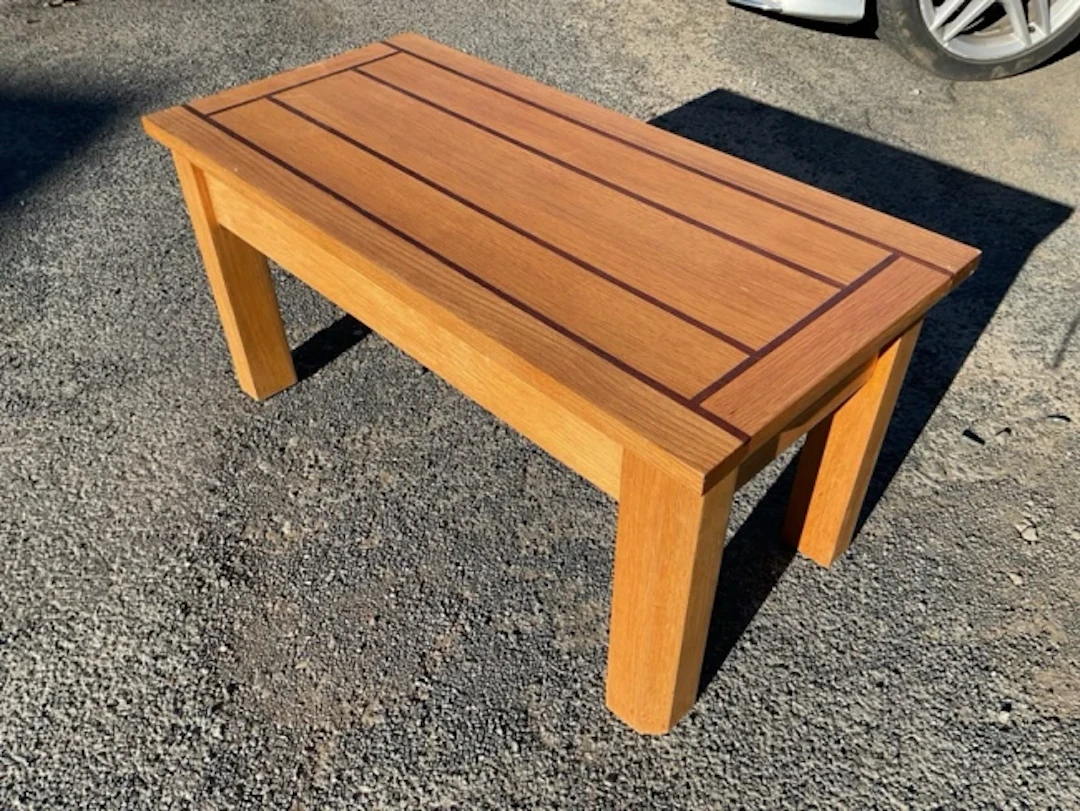 A rectangular cabinetmaker made oak and iroko banded bench coffee