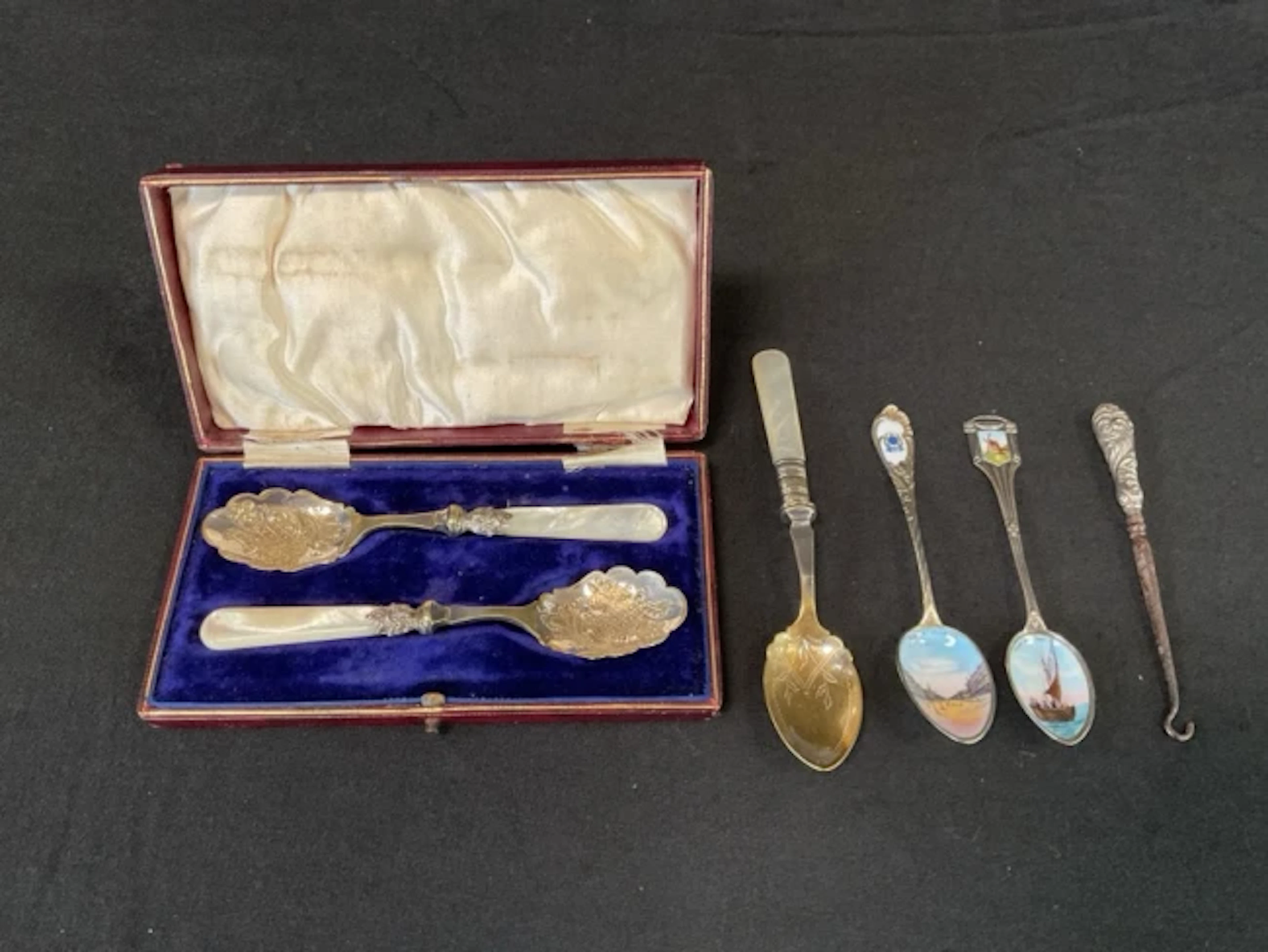 A Belgian silver enamelled Heyst-Sur-Mer spoon; a boxed pair of silver