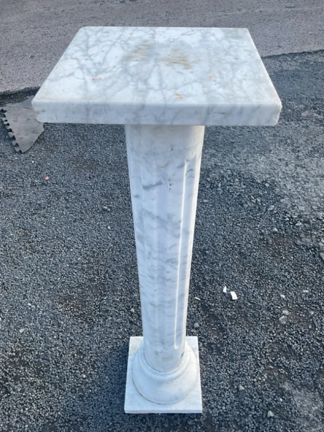 A marble jardinière stand with square platform top on fluted column