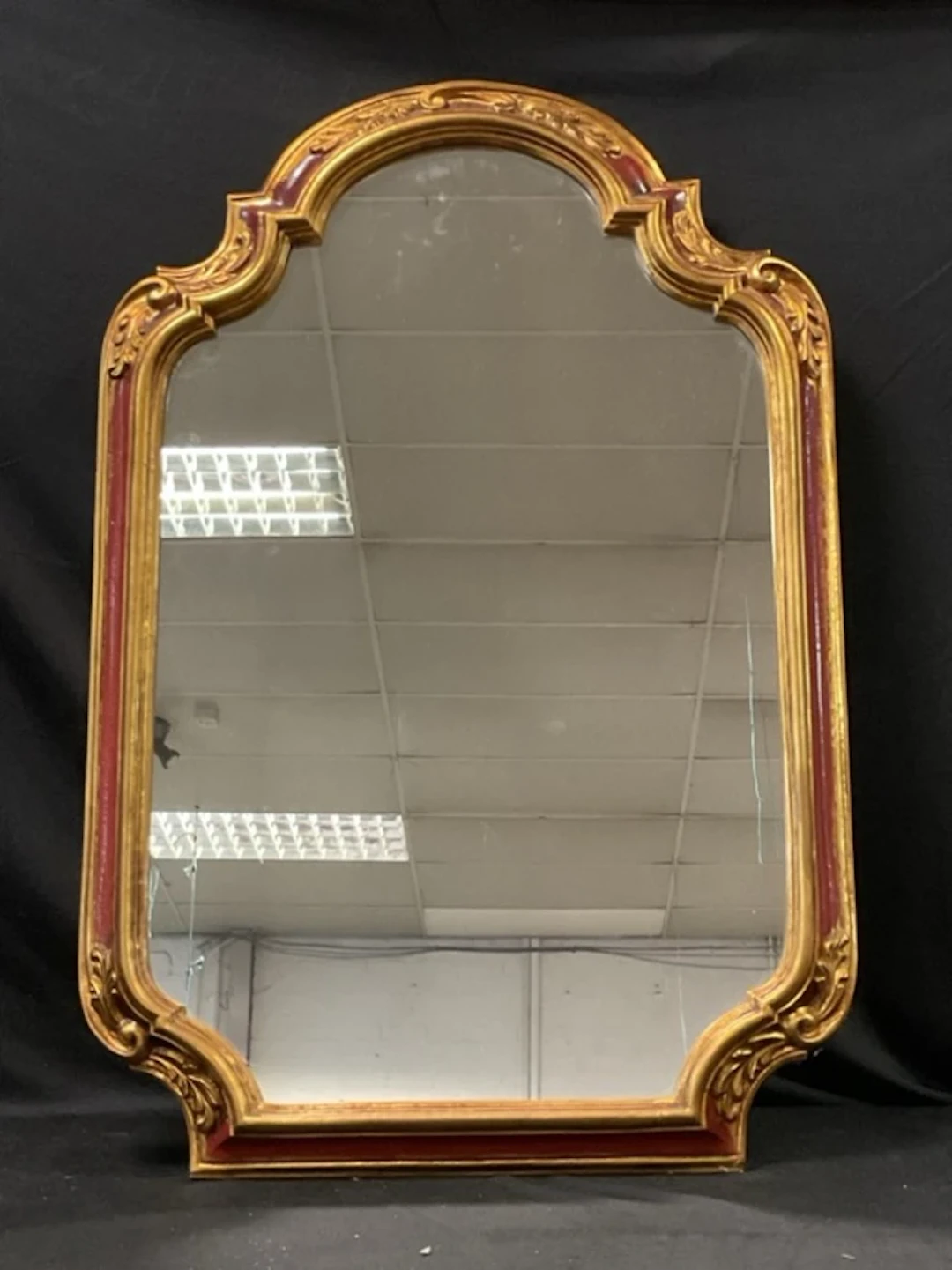 A Georgian style gilt framed pier glass with arched foliate moulded