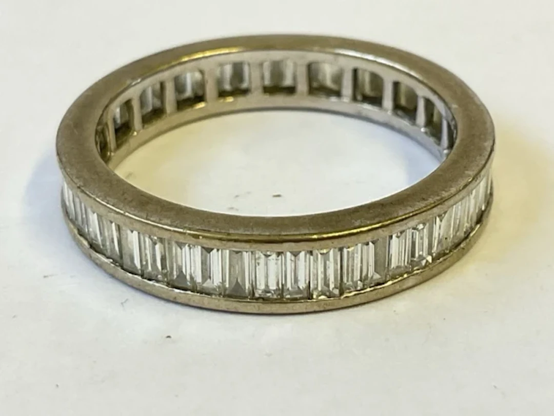An 18ct white gold eternity ring with channel set baguette cut diamonds