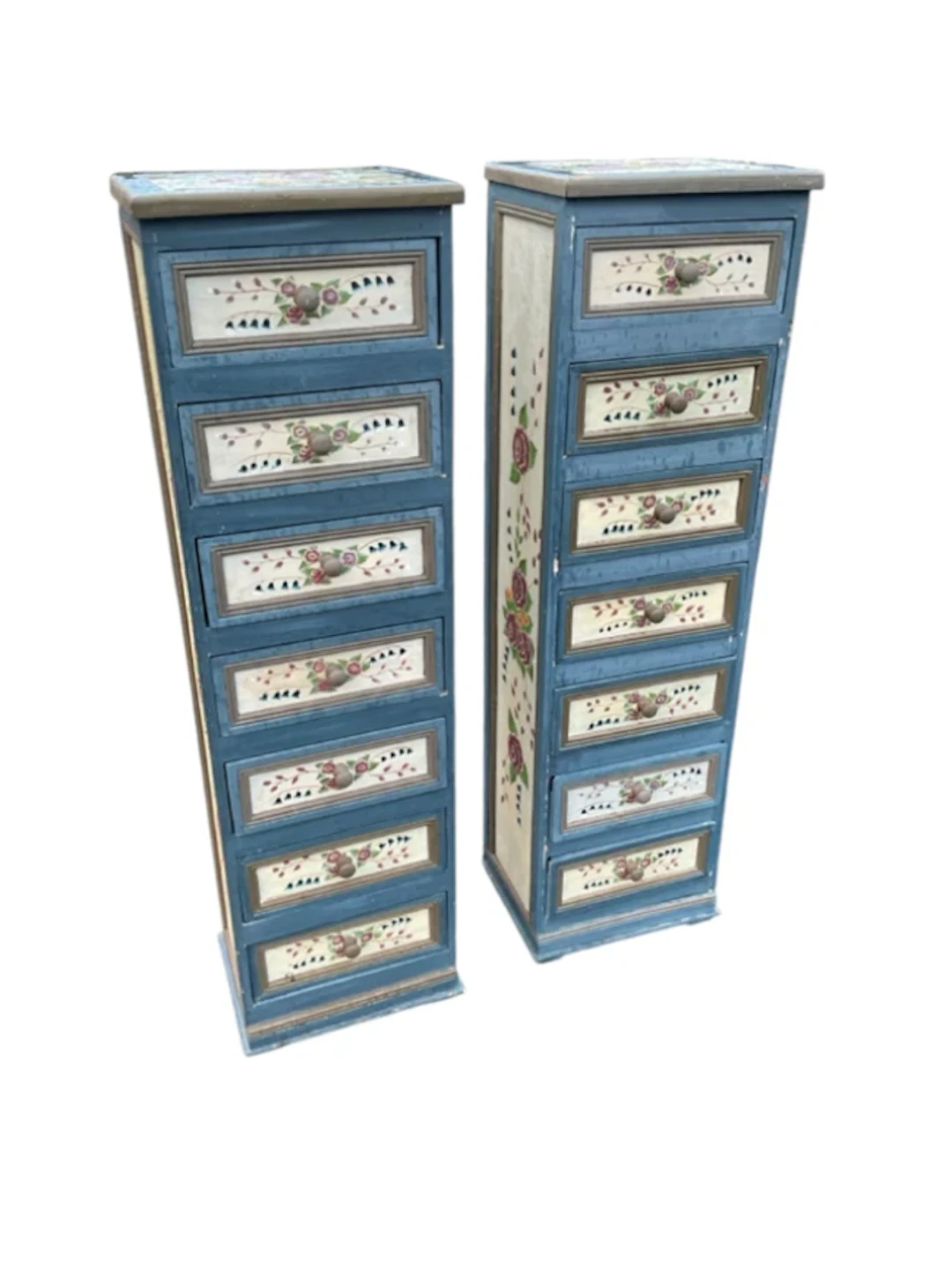 A pair of floral painted tower cabinets, each containing seven panelled