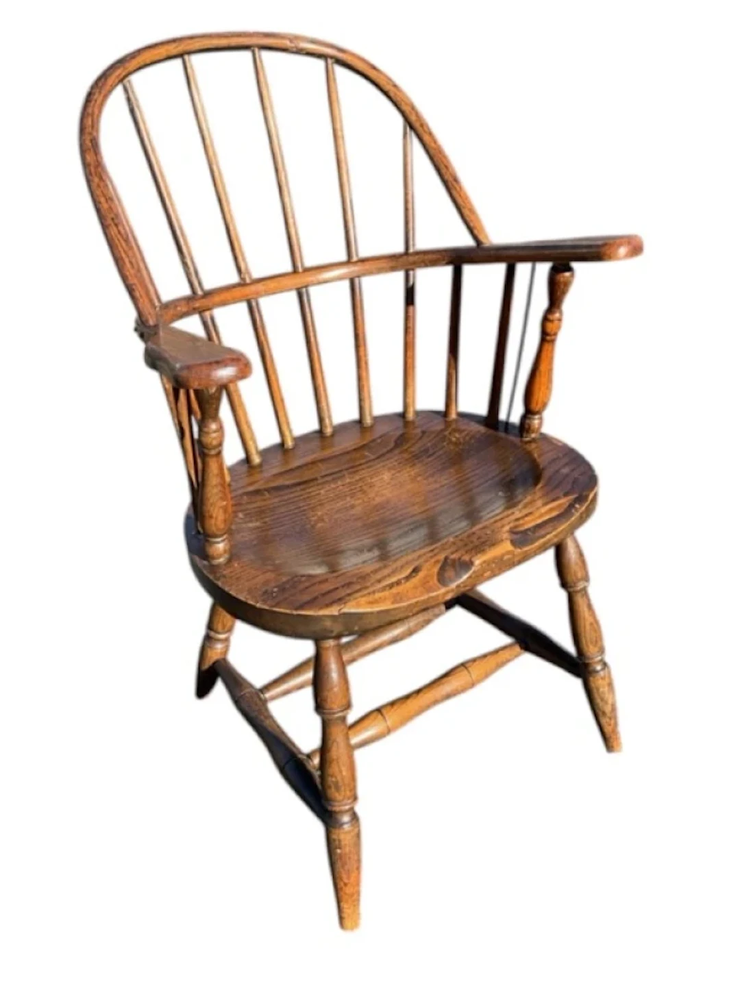 An American elm windsor chair with hooped back on spindles, having