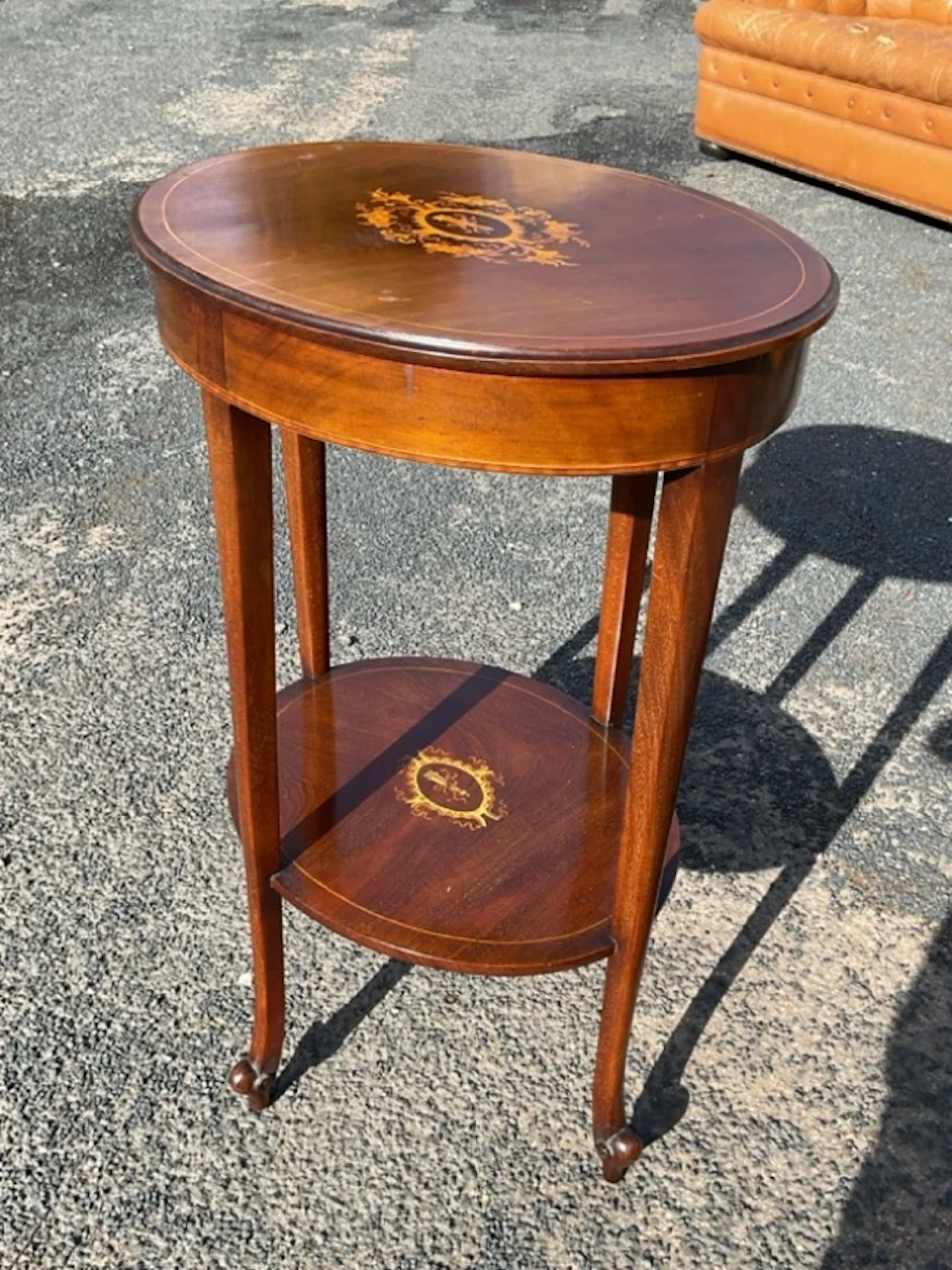 An Edwardian boxwood strung mahogany occasional table with oval moulded