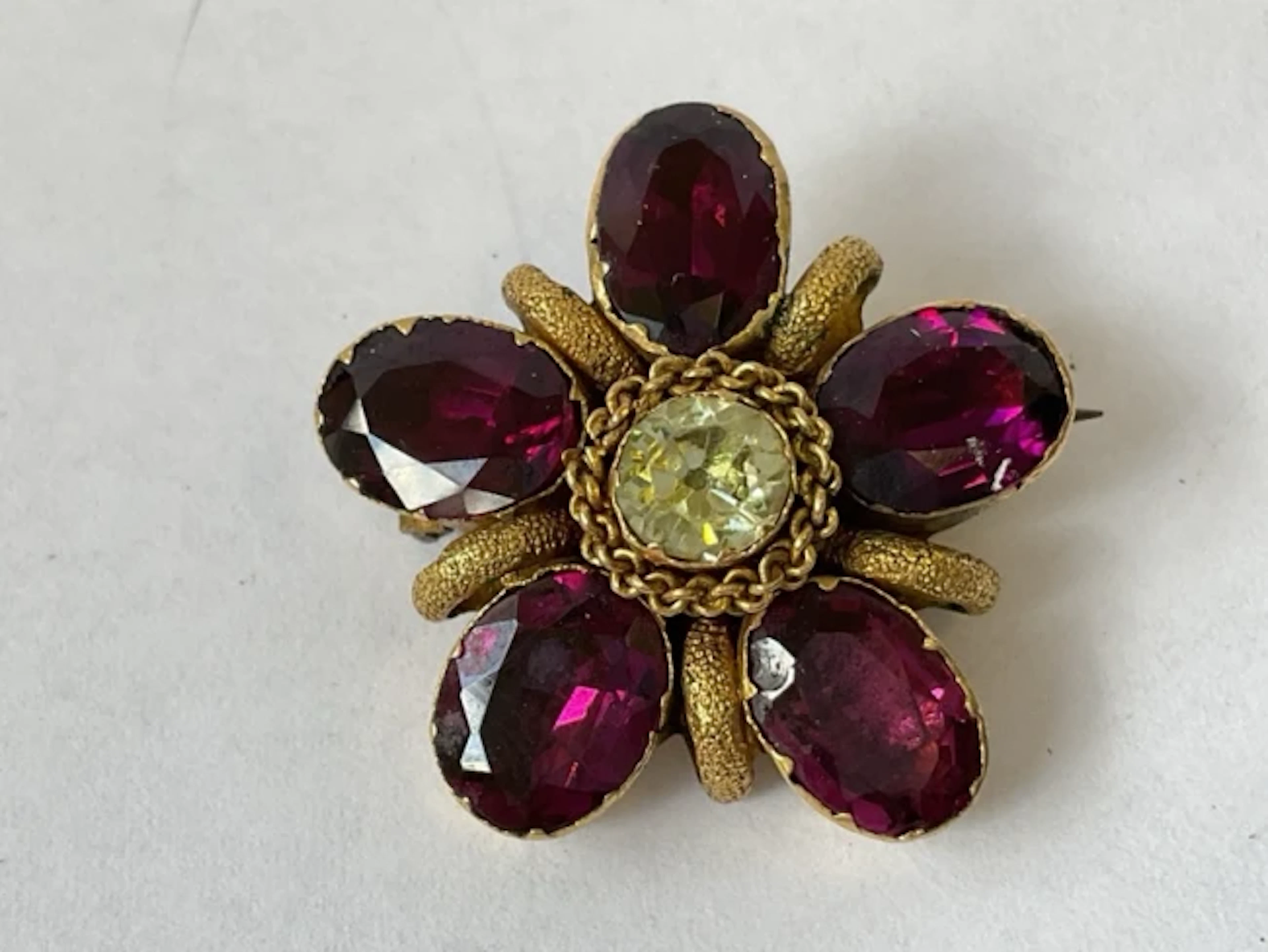 A Victorian unmarked gold brooch in the form of a flower, the oval