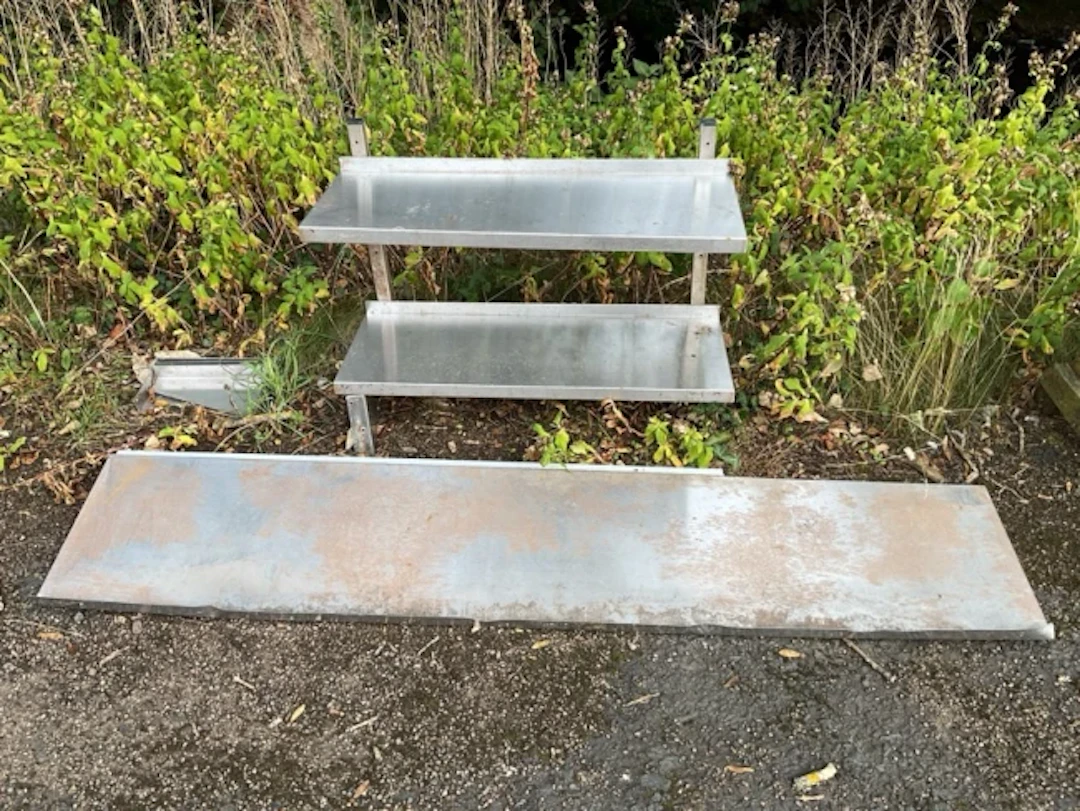A pair of rectangular stainless steel wall shelves on square battens
