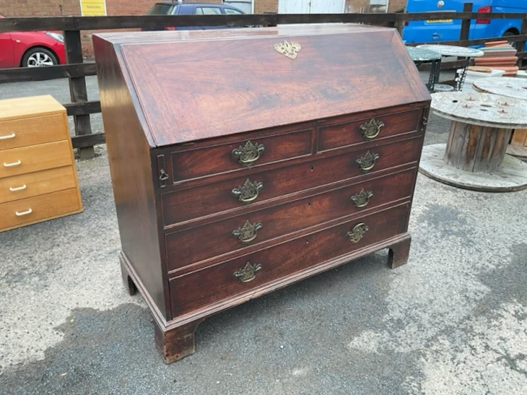 A George III mahogany bureau having fitted interior with small drawers